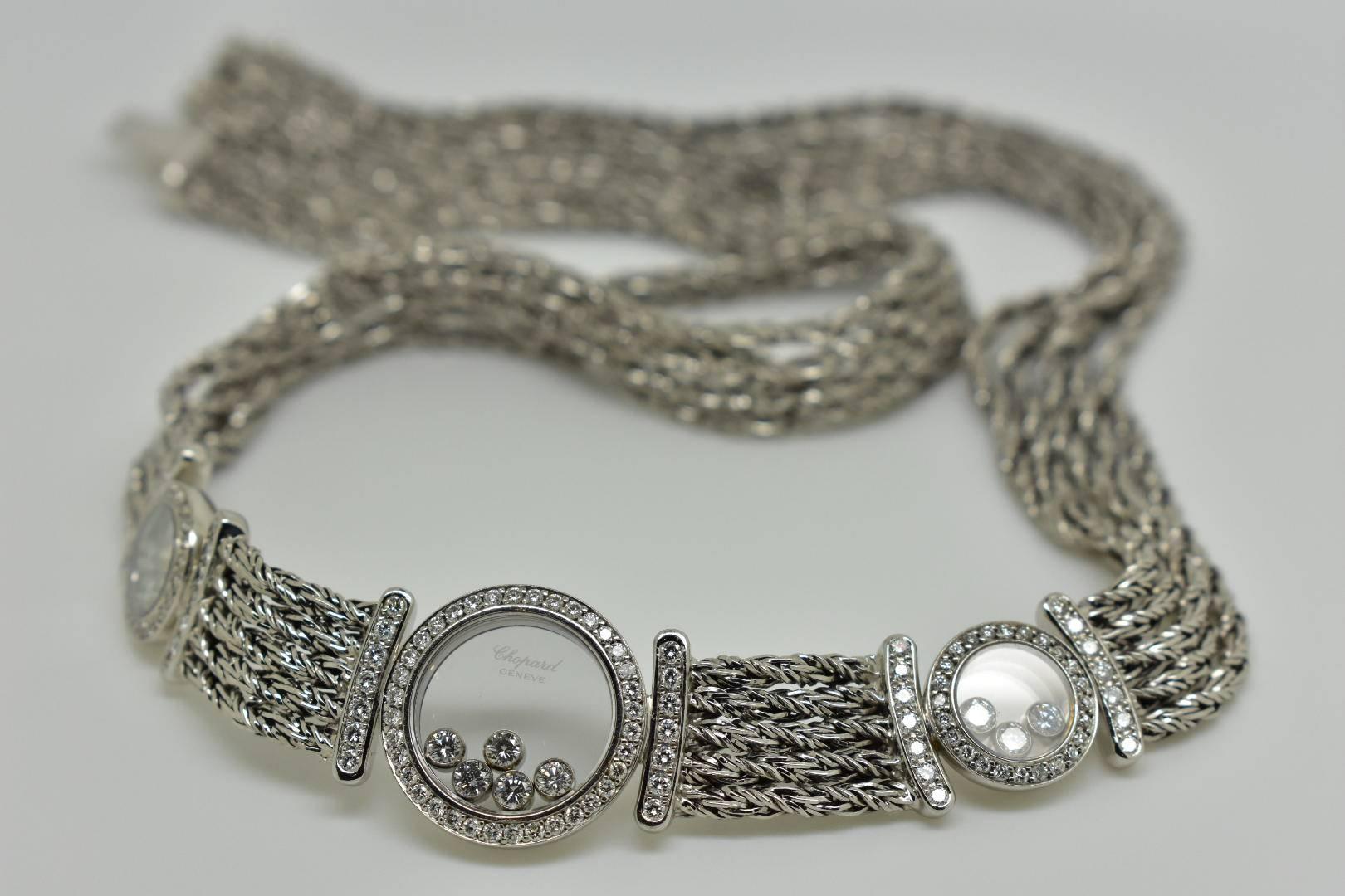Chopard 'Happy Diamonds' four strand necklace set in 18k white gold. The necklace feature three circle motifs with free moving brilliant-cut under a sapphire glass. The central circle features five diamonds of approx .25 carats, and the two smaller