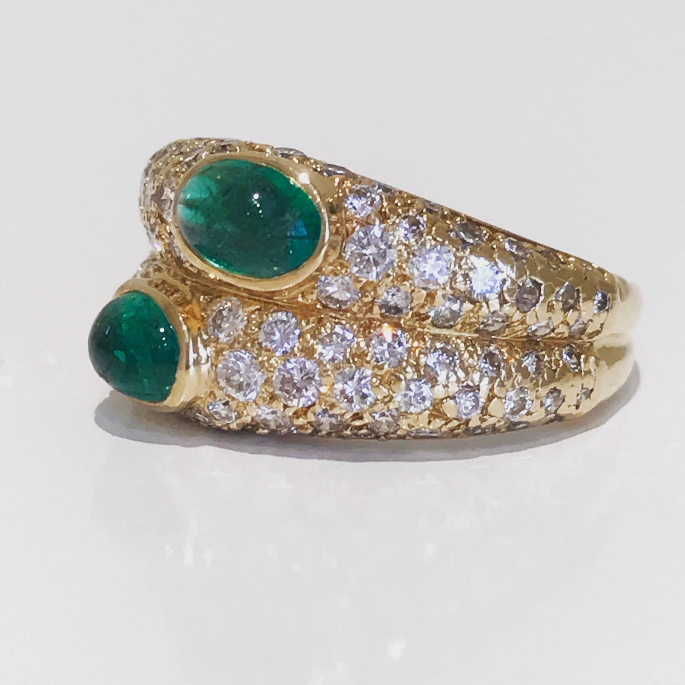 Vintage Cartier two cabochons emerald and diamond ring set in 18 karat yellow gold. The ring features seventy brilliant cut diamonds of approx 1 carat and emeralds of approx .60 carats
Colour: G
Clarity: VVS1 clarity 
Hallmarked Cartier 750, 636293.