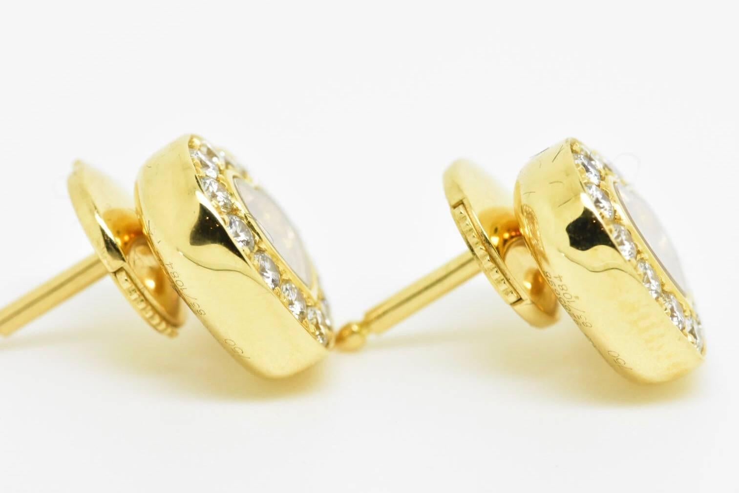 Chopard 'Happy Diamonds' Icons earrings set in 18k yellow Gold. Each earring is designed with a free moving diamond held between two sapphire crystals with a diamond set border. Retail price £3,990
Hallmarks: Chopard, 9285698 83/1084. 
Estimated
