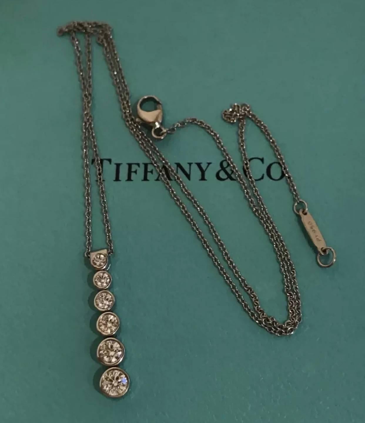 Tiffany & Co Platinum Diamond Jazz Drop Necklace set in platinum. The necklace features 6 round brilliant cut diamonds totalling approx 0.45 carat weight of F colour and VS1 clarity. The pendant measures 22.5mm long and 4.6mm wide and the chain