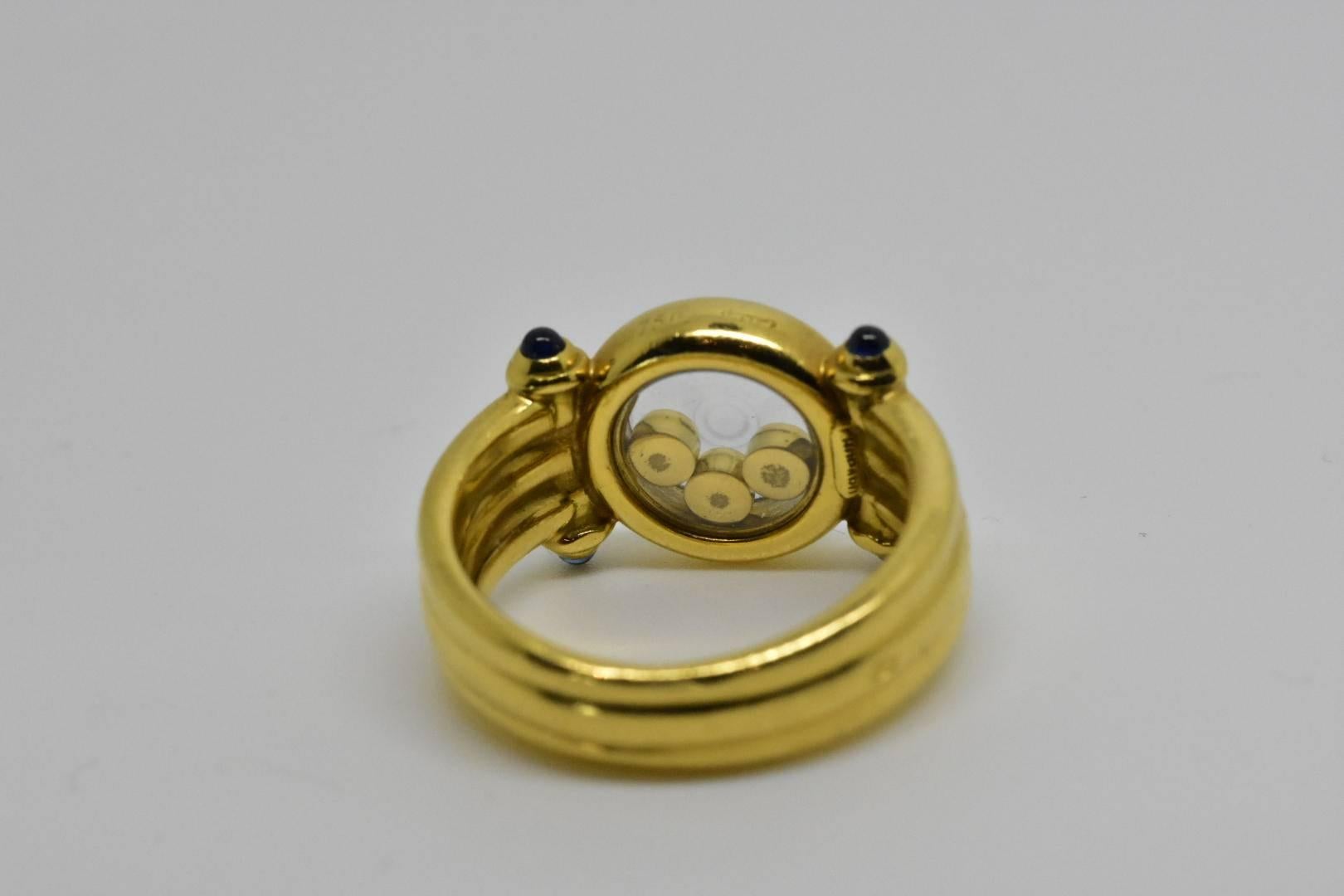 Chopard vintage Happy Diamonds ring finely crafted from solid 18k yellow gold. The ring comes from Chopard's popular Happy Diamonds collection. It features three floating diamonds all in bezel setting and is encased in a double round shape crystal