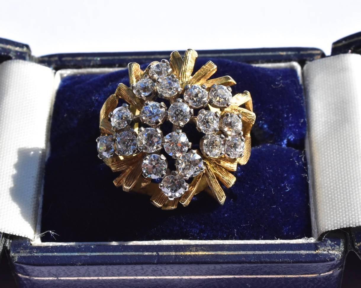 A Large vintage 1970's diamond Cluster ring set in 18k yellow gold. The ring features carved textured style branches with a cluster of nineteenth brilliant-cut round diamonds of approx 0.18 to 0.20 carat totalling approx 3.50 carat. The diamonds are