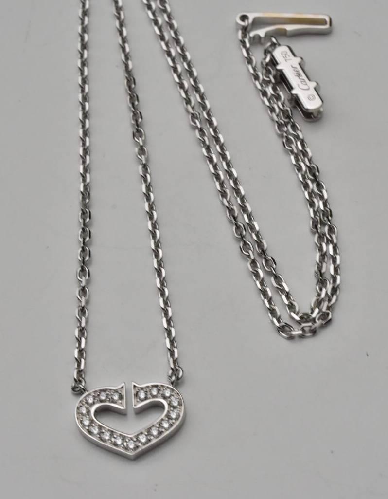 A Cartier a diamond 'Symbols', 'C Heart of Cartier' necklace set in 18k white gold. The necklace features a brilliant-cut diamond stylized heart, suspended from an integral, filed trace-link chain.
Current retail price £3,850
Hallmarked: Cartier, OX