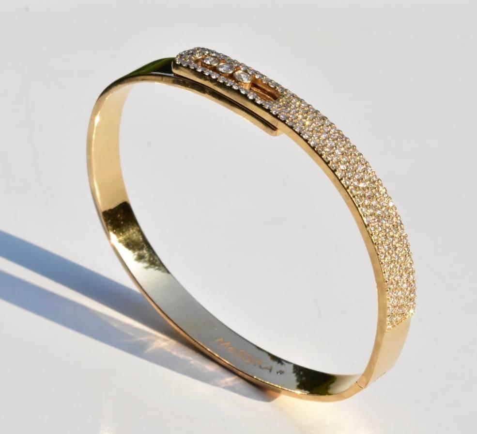 A Messika Move Noa Diamond bracelet set in 18 yellow gold. The bracelet features a shimmering half pavé front with three sliding bezel-set diamonds fitted in an oval framewith a clasp fastening
Designer collection: Move Joaillerie 
Measurements: