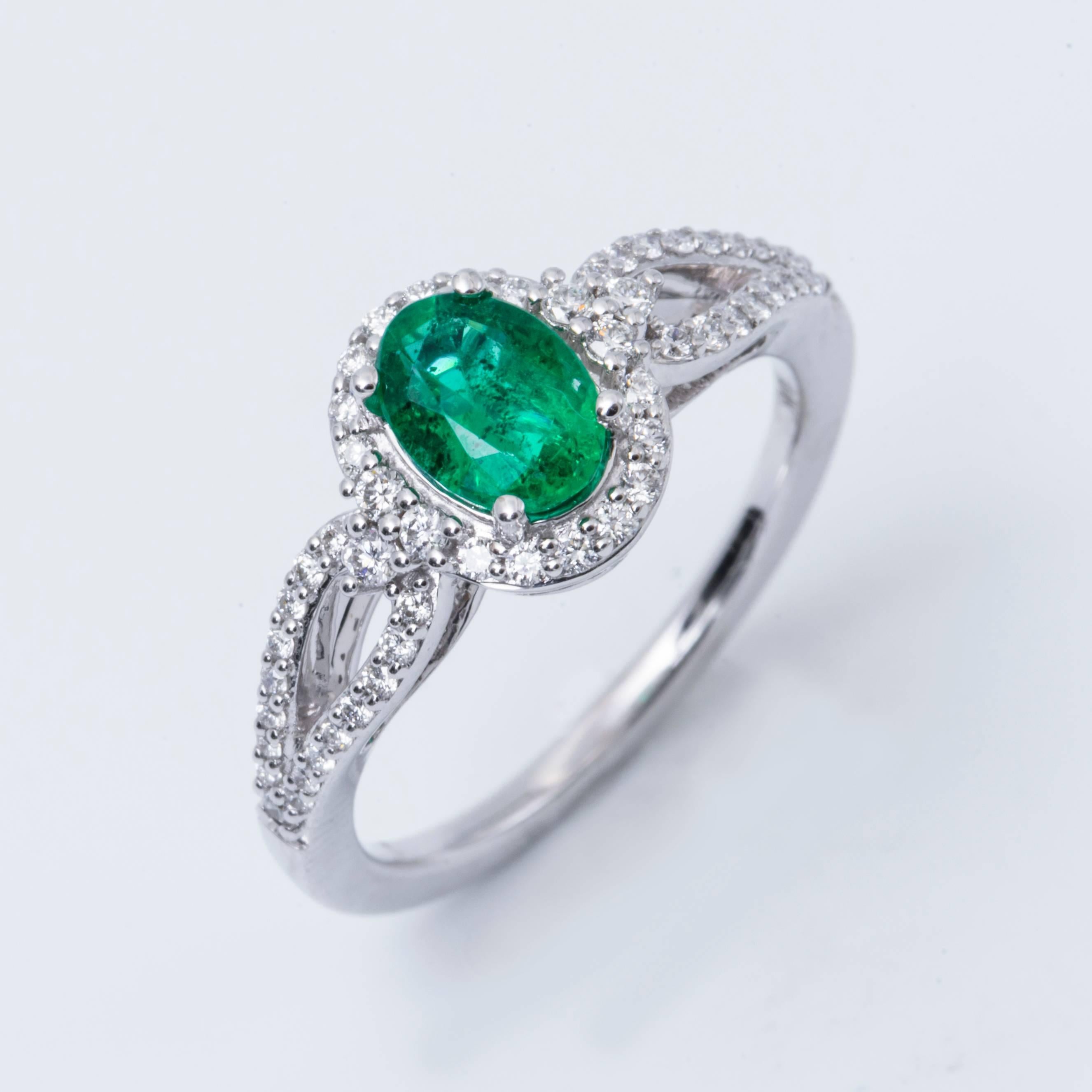 14K white gold, the beautiful Zambian emerald measures 7x5 mm and weighs 0.71 cts..The diamonds weight is 0.32 cts with H Color and SI Clarity.