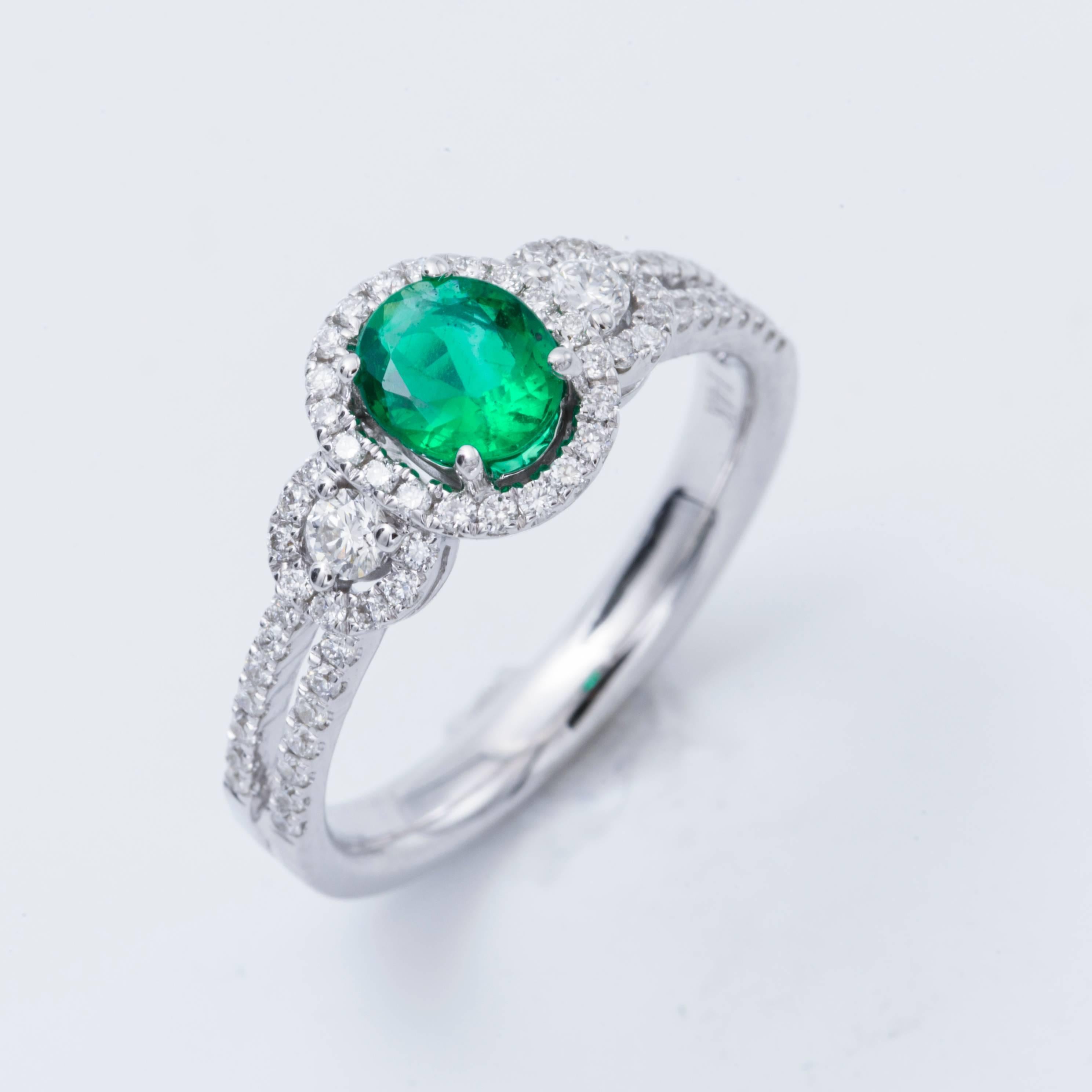 Style: 14k White Oval Shape Zambia Emerald  Diamond Halo Engagement Ring
Material: 14k White Gold
Gemstone Details: 1 Oval  Shape Emerald approximately 0.50 ct. 6x5mm
Diamond Details: Approximately 0.43 ctw of diamonds. Diamonds are G/H in color and