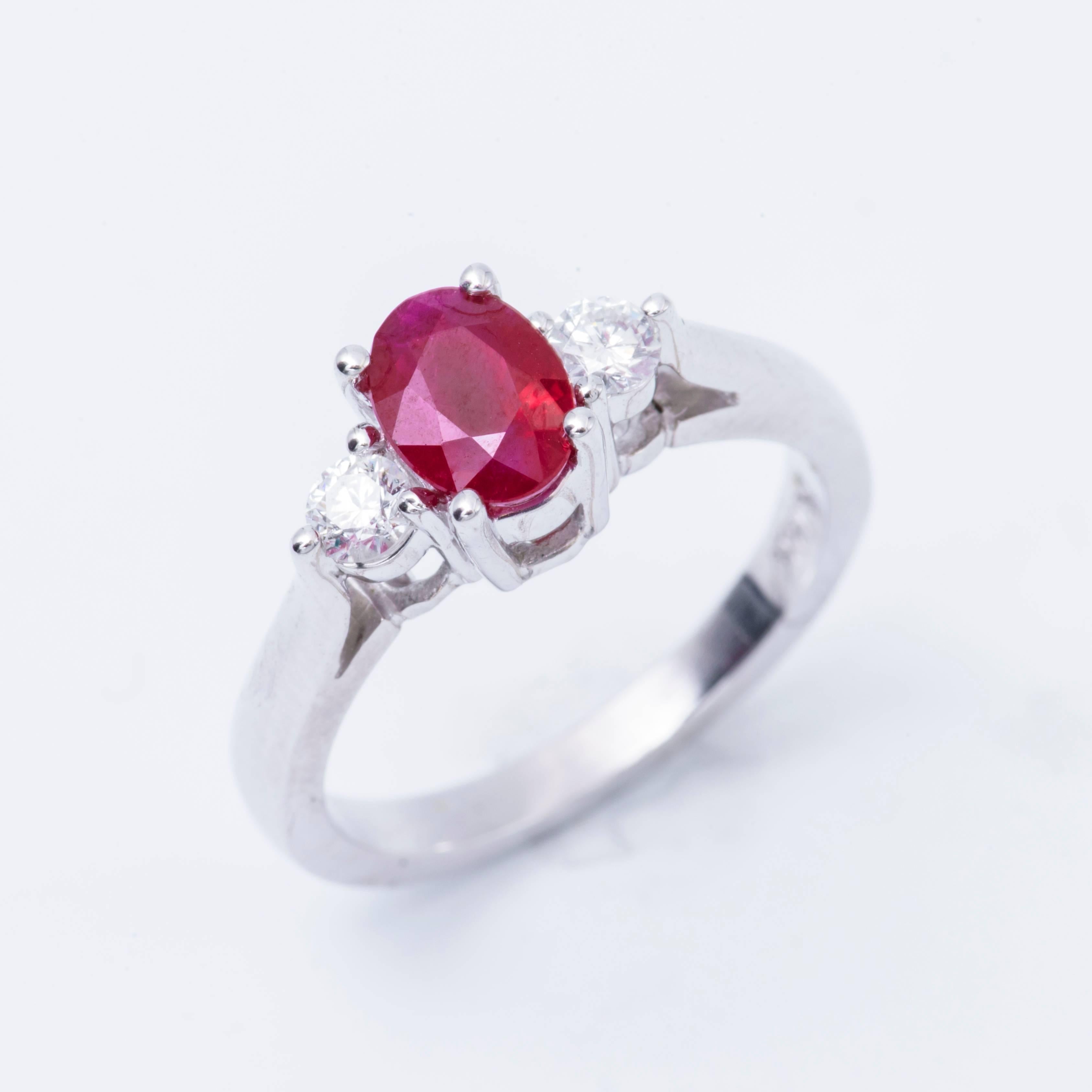 Style: 14 K  Oval Shape Ruby Diamond 3 stone  Engagement Ring
Material: 14k White Gold
Gemstone Details: 1 Oval Shape Ruby approximately 1.03 ct. 7x5 mm
Diamond Details: Approximately 0.22 ctw of diamonds. Diamonds are H in color and SI in