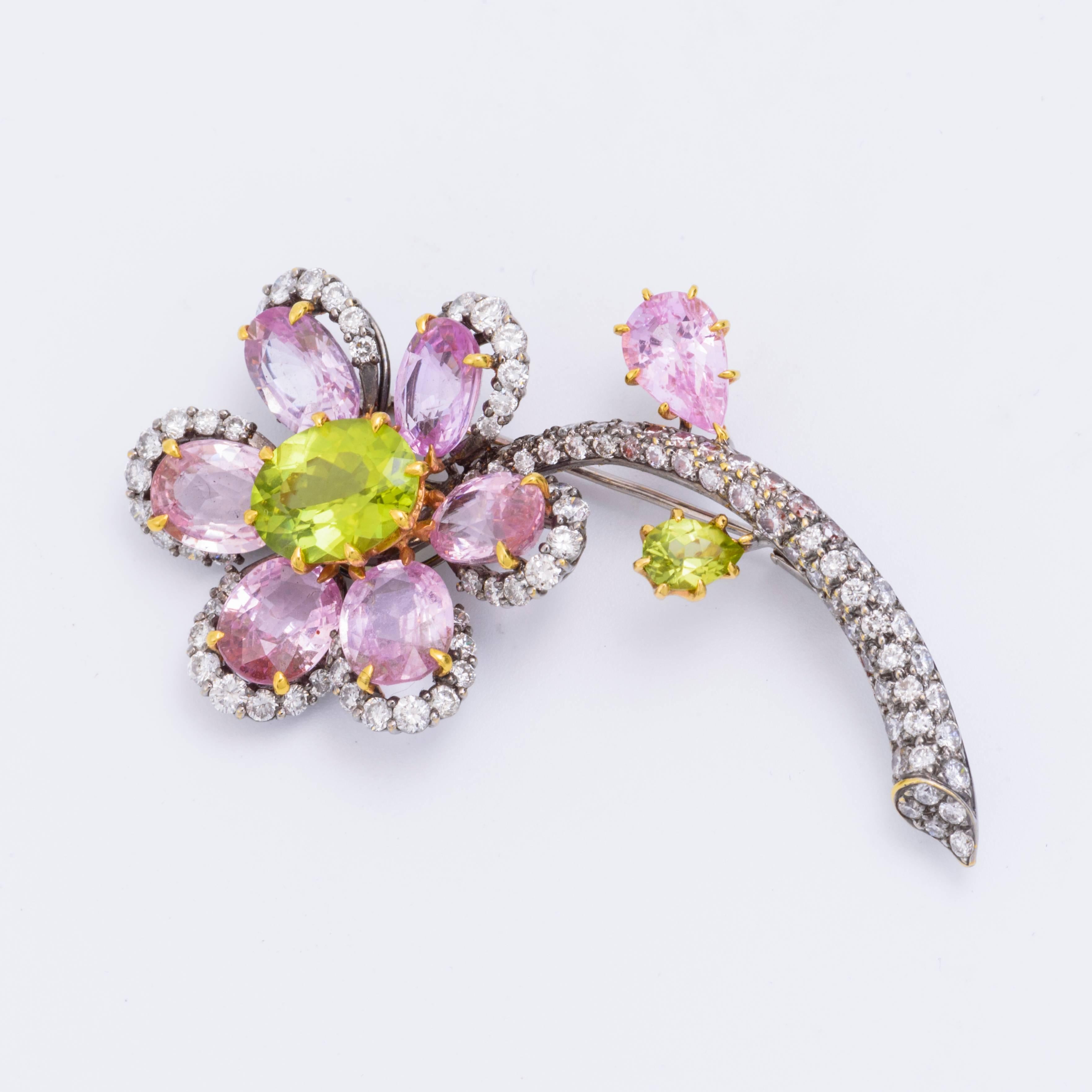 18kt Gold Flower Pin featuring White Diamond, Pink Sapphire, and Green Peridot.
108 White Diamonds 3.00ctw
7 Pink Sapphire
2 Green Peridot