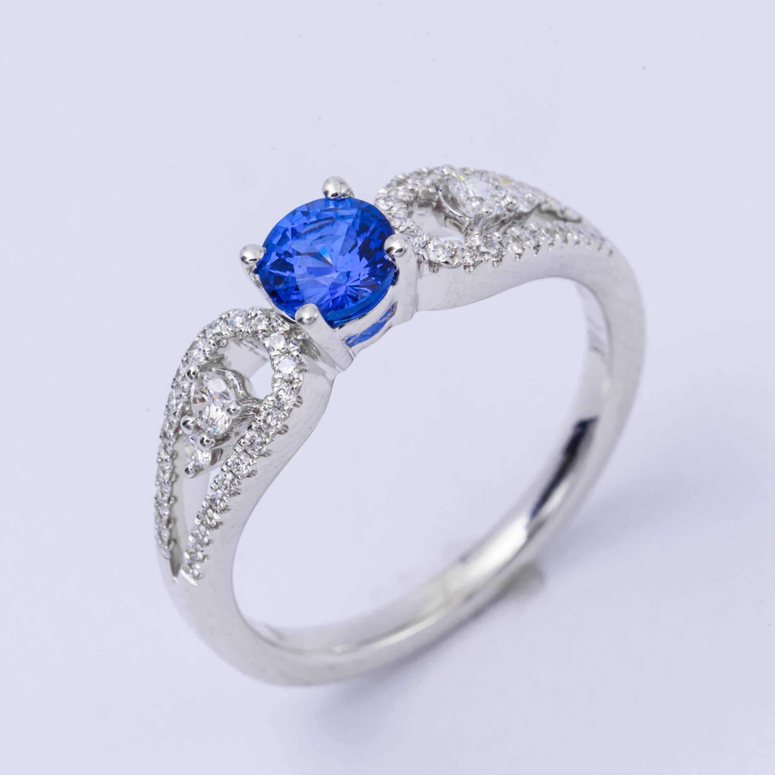 Style: 14k White Ceylon Sapphire  Diamond Engagement Ring
Material: 14k White Gold
Gemstone Details:  Sapphire approximately 0.64 ct. 5 mm
Diamond Details: Approximately 0.20 ctw of diamonds. Diamonds are H in color and SI in clarity.
Ring Size:
