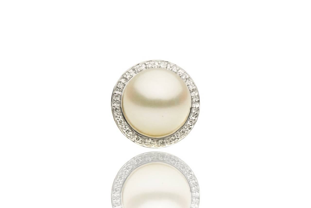 These beautiful stud earrings feature:

Fresh water Cultured  Pearl size; 8-9mm
Quality: AAA
Luster: AAA
Nacre: Very Thick
Earring Style: Studs
Metal Weight: 2.0 g.
Diamond: 40
Diamond Weights: 0.12 cts.