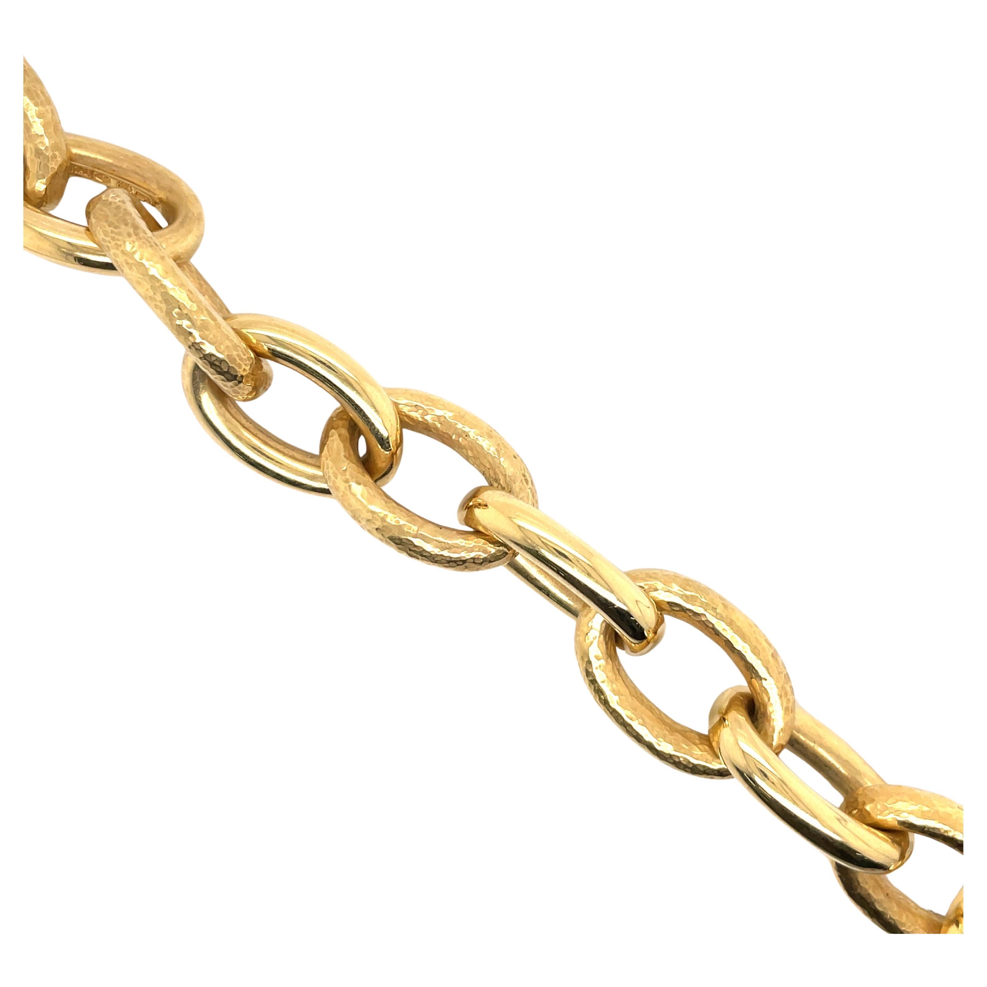 18 Karat Yellow gold bracelet featuring 11 oval links in a high polish and hammered finish weighing 46.1 grams.
Oval link is 1 1/8 inches long by 13/16 inches wide. 
Email for more link and gold bracelets.