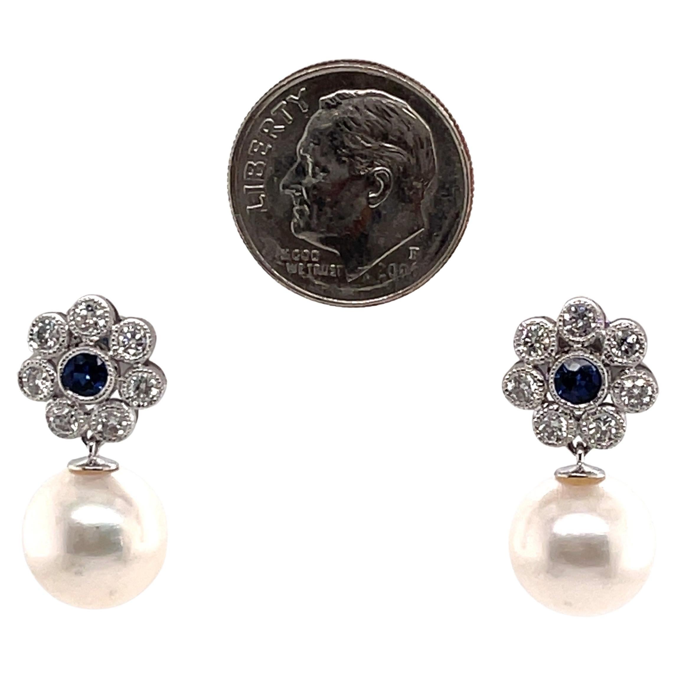 14 Karat white gold 2.4 grams 
White fresh water pearl 10-11 mm
14 Round diamonds weighing 0.40 cts
2 Round blue Sapphires weighing 0.70 cts