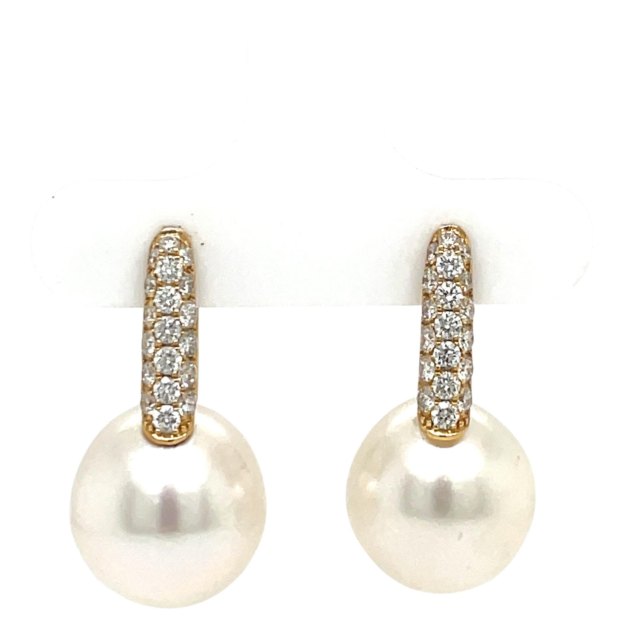 18 Karat Yellow Gold drop earrings featuring 38 round brilliants weighing 0.61 carats and two South Sea Pearls measuring 12-13 MM.
Color G-H
Clarity SI

Earrings available in different gold colors and pearls. 
DM for more information & pictures. 