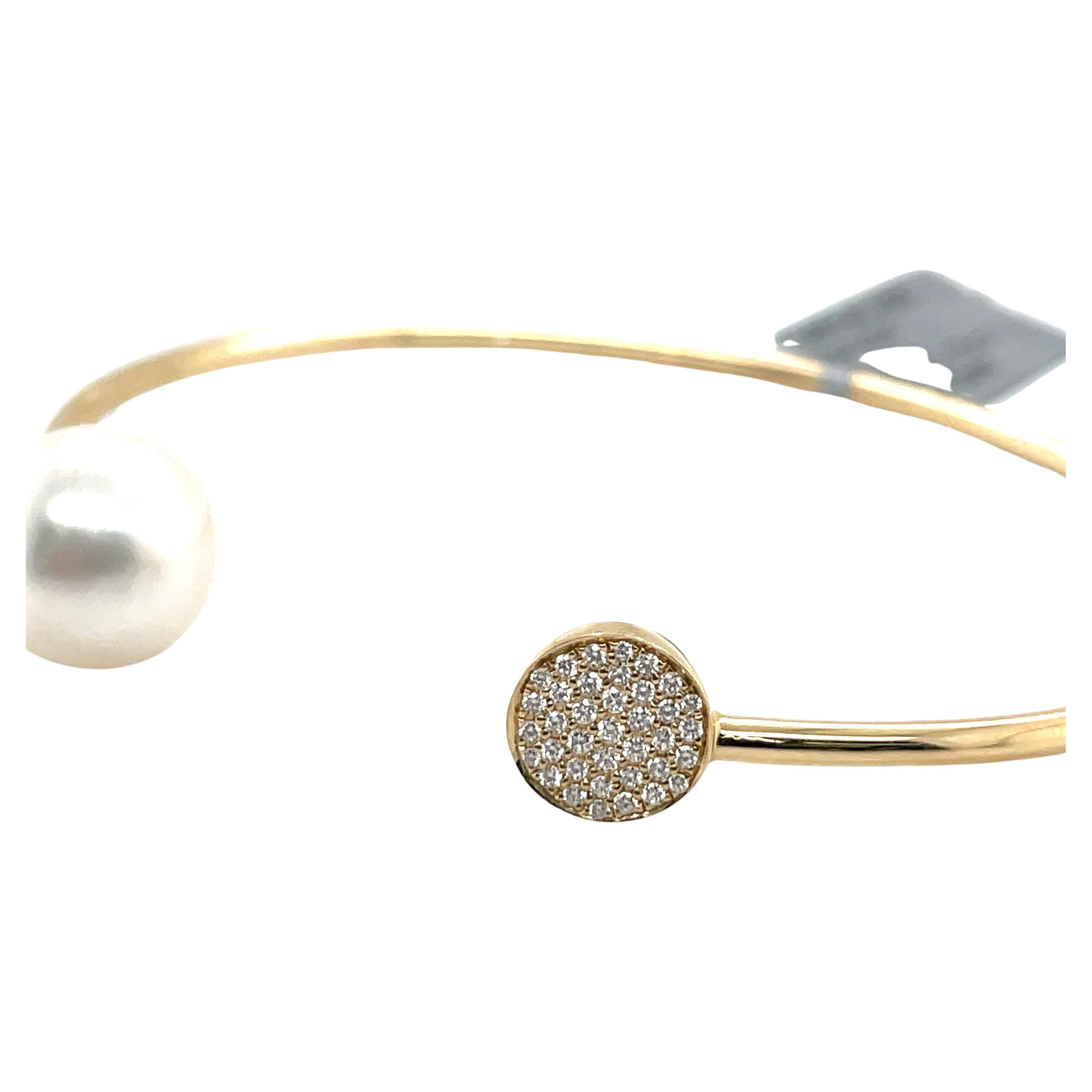 14 Karat Yellow Gold open bracelet cuff featuring 37 round brilliants weighing 0.13 Carats and one South Sea Pearl measuring 11-12 MM.
Comes in White Gold and can customize Pearl Color 