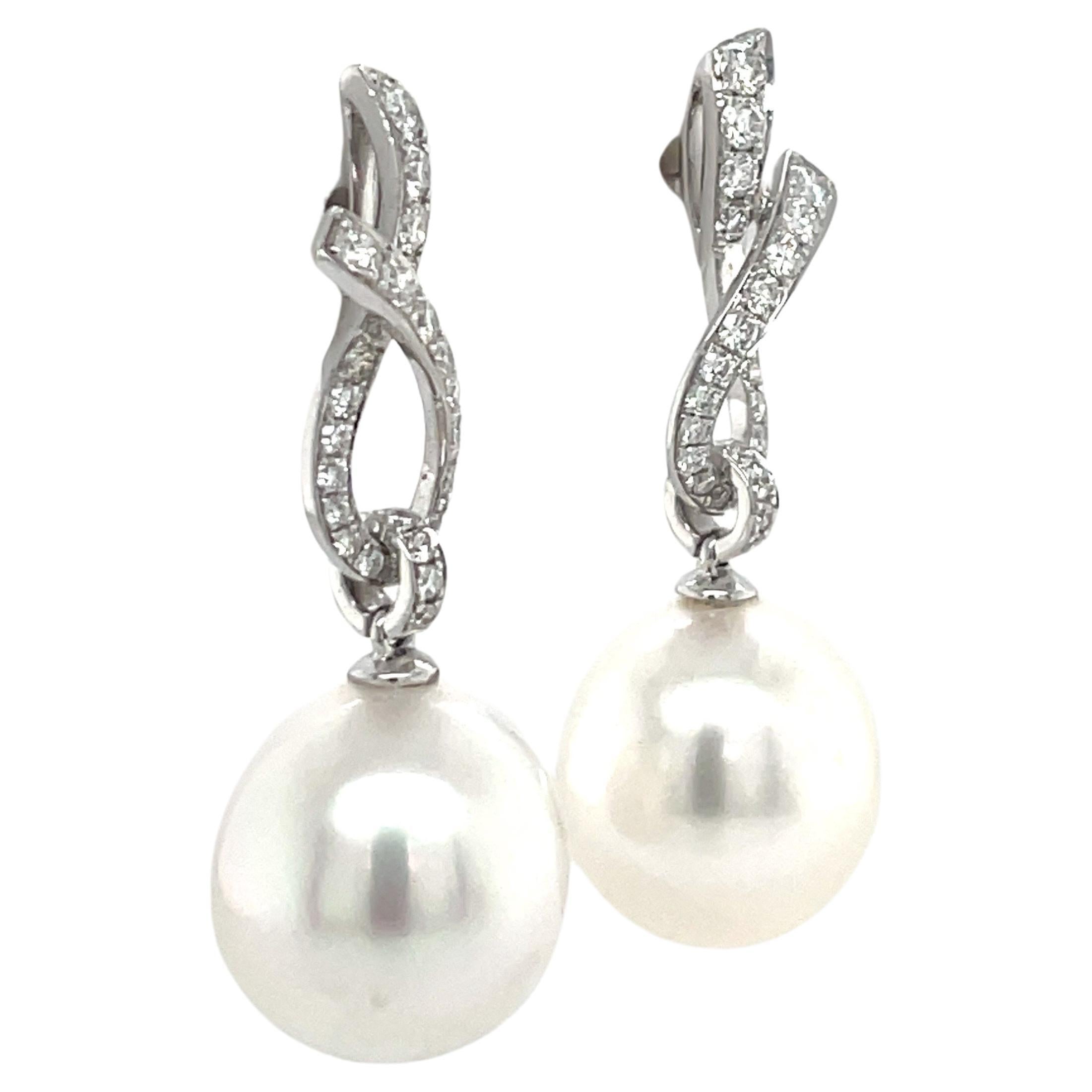 Round Cut 18 Karat White Gold Diamond Ribbon South Sea Pearl Earrings .057 Carats For Sale