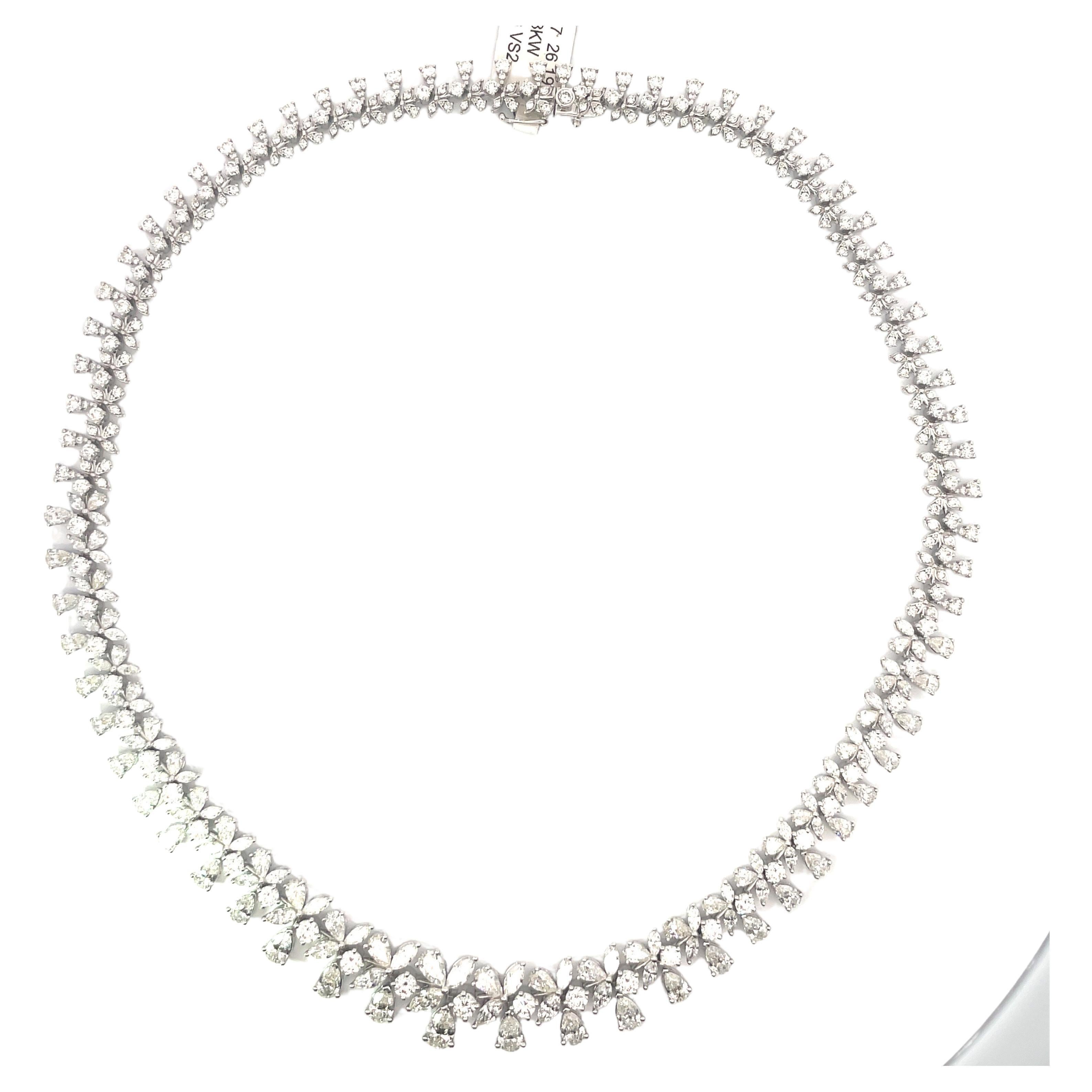 18 Karat White Gold drop necklace featuring a floral cluster of Pear, Marquise & Round Brilliant diamonds weighing a total of 26.19 Carats.
Color F-G
Clarity VS2
A real show stopper!