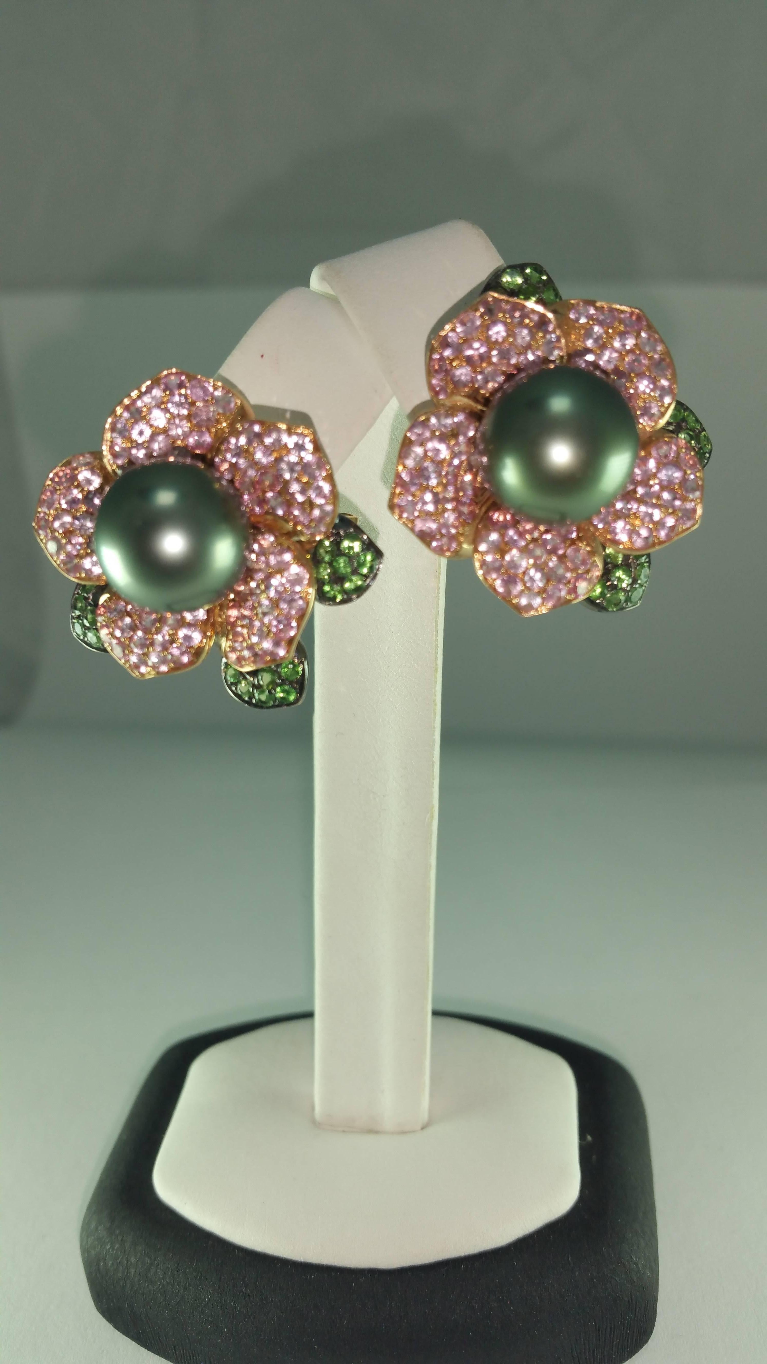 Tahitian Pearl Flower Diamond Gold Earrings
18 K Rose Gold
Pearl size: 11 - 11.5 mm
5.44 TW cts. Pink sapphire and Green Garnet
2.0 cm/ 2.5 cm 