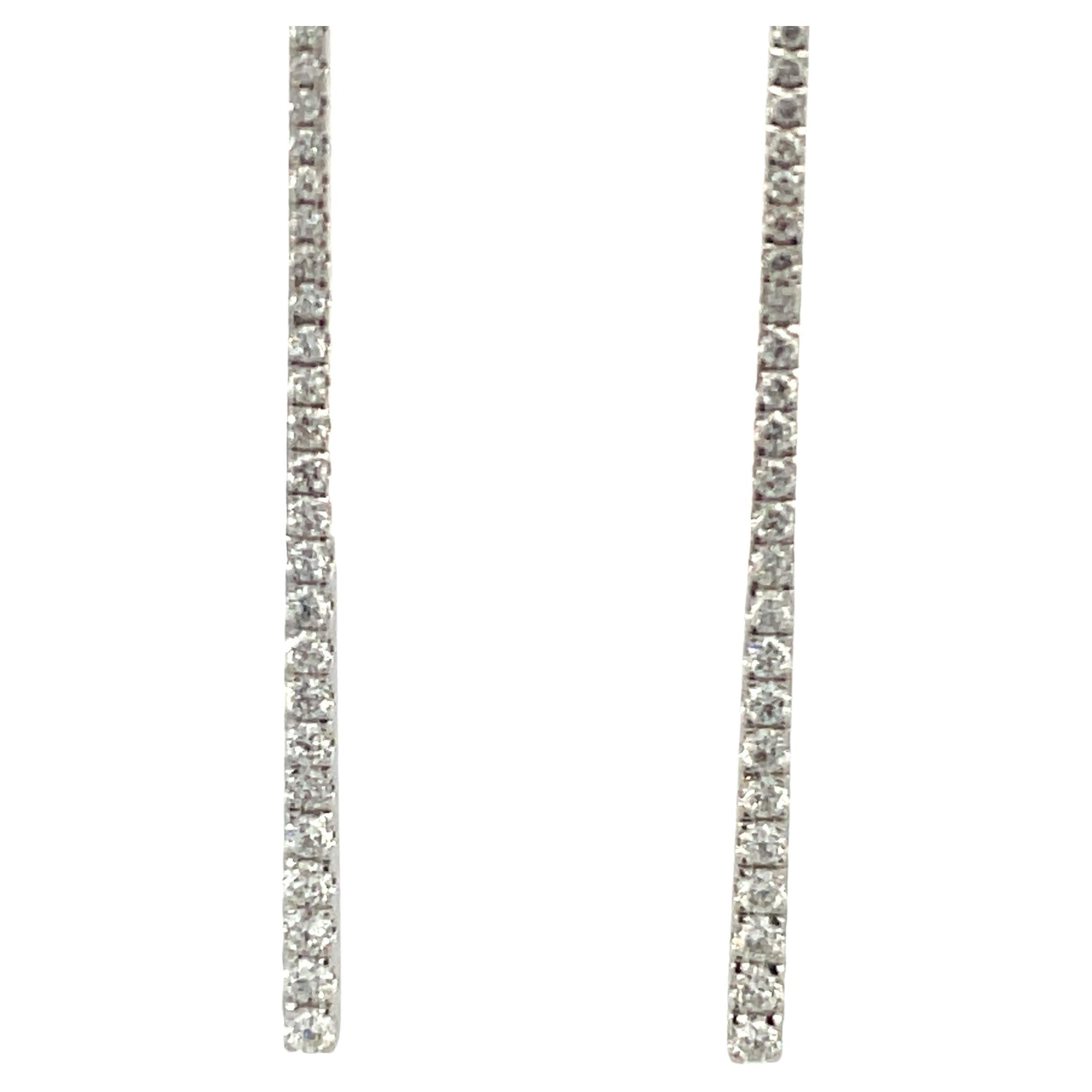 18 Karat white gold long drop earrings featuring a bar motif containing 88 round brilliants weighing 0.97 carats. 
Color G
Clarity SI