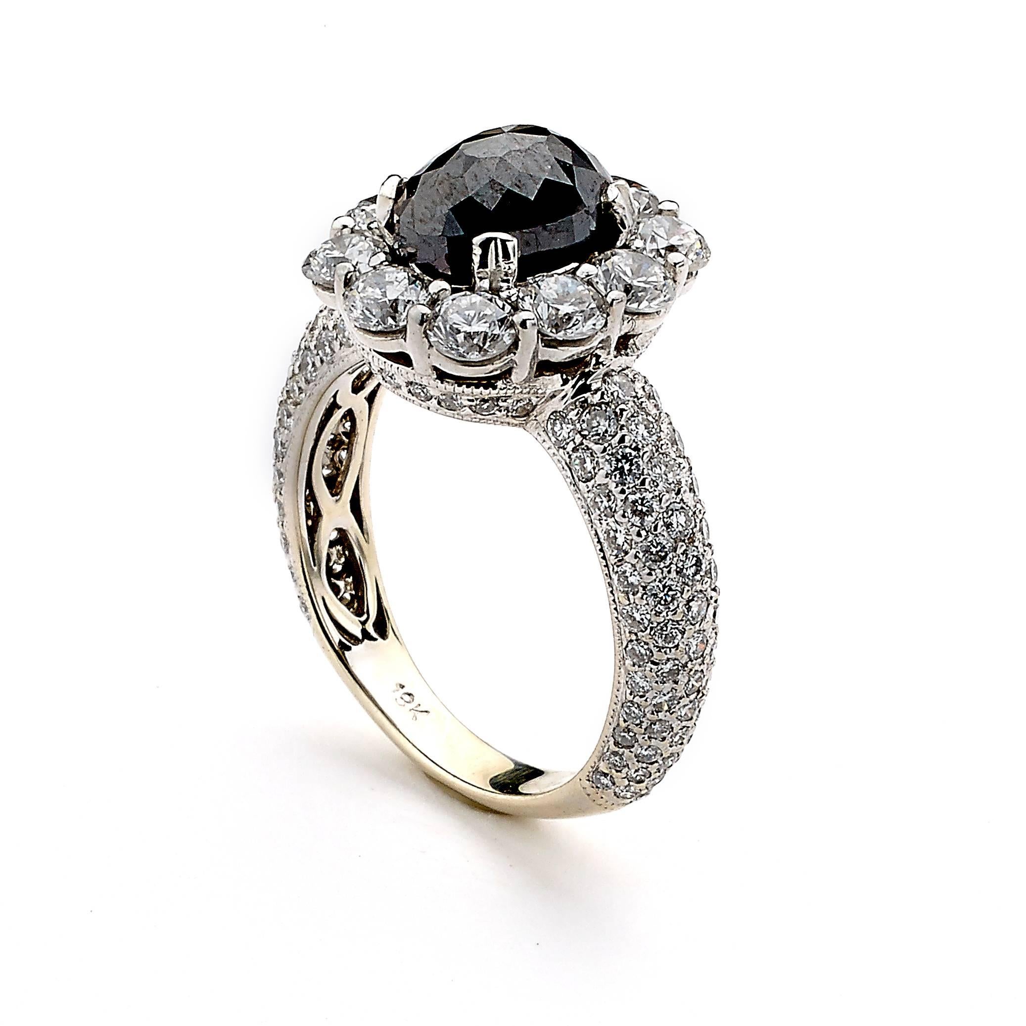 A stunning ring, polished in 18K Gold to add more luxury to the design.
Classic and Elegant, this piece houses a rich black oval Rough Diamond Center surrounded by beautifully matched White Diamonds.
 
Rough Black Diamond Weight: 2.31 cts.
White