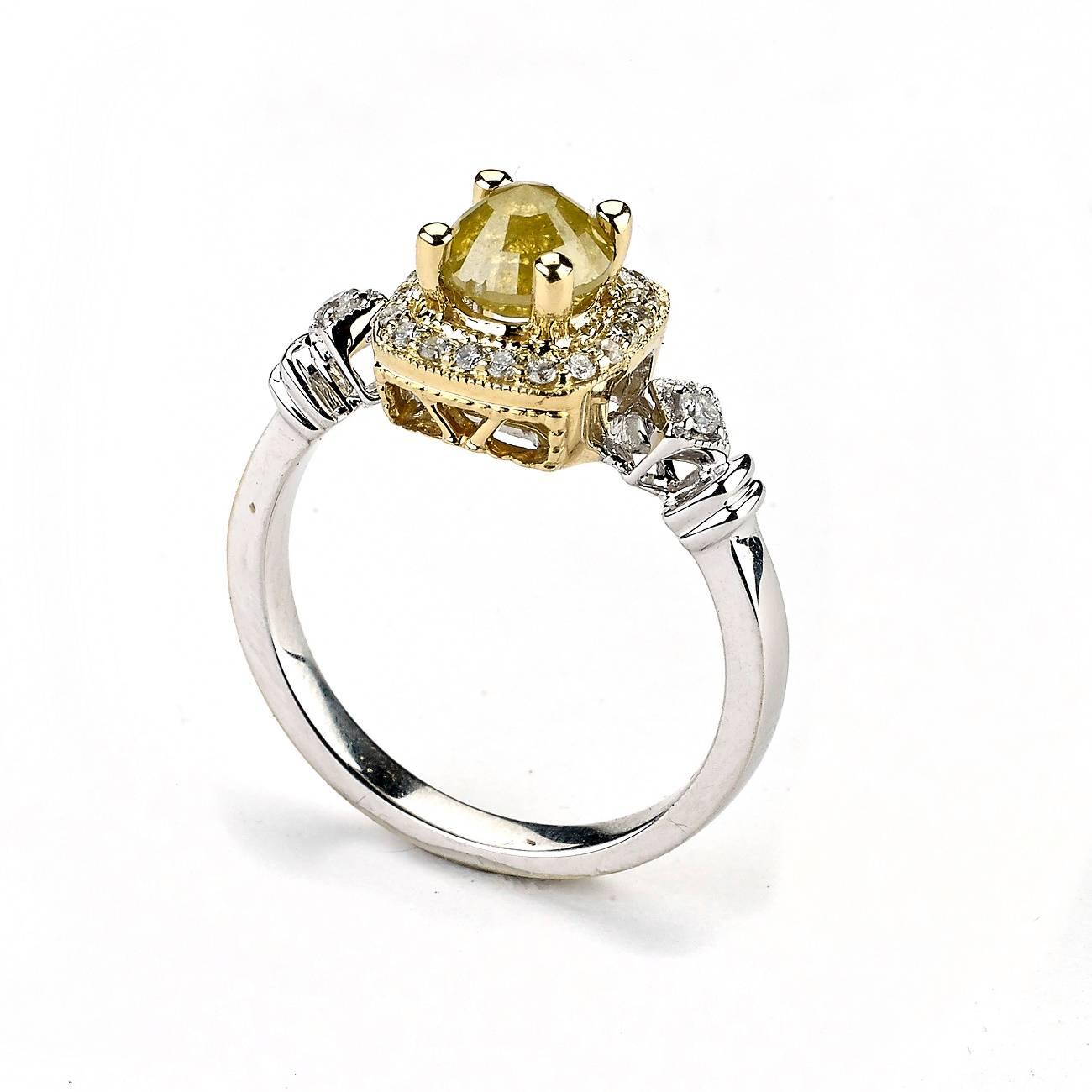 This Ring features a Fancy Yellow Diamond Surrounded by White Diamond Accent and Lays in two Tone Yellow and White Setting.

Yellow Diamond: 1.08 Cts.
Diamond Cut: Cushion
Clarity; SI1-SI2
Color: Yellow
Setting : Prong

White Diamonds: