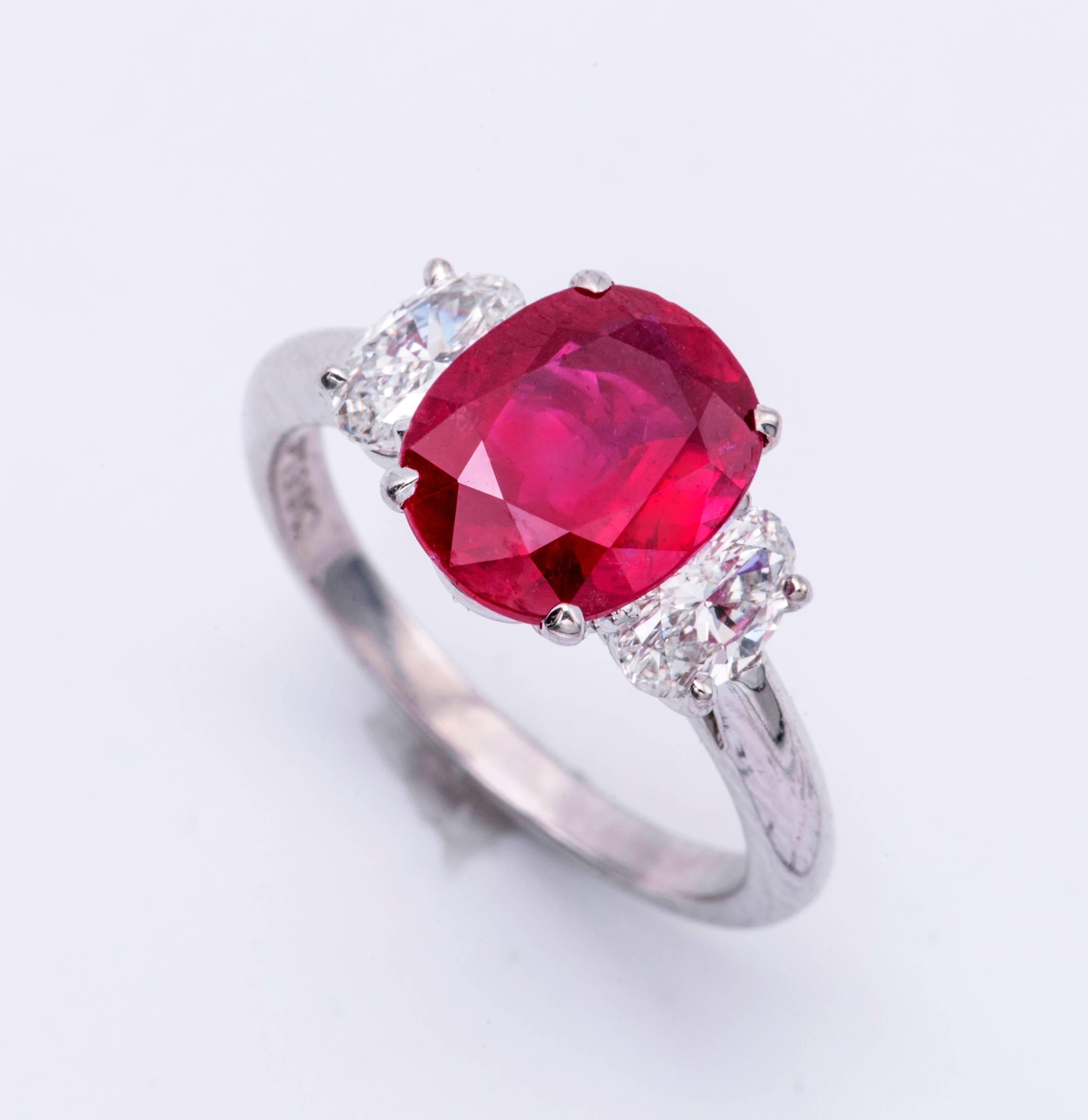 This one of a kind Ring is set in platinum, the Ruby comes with a certificate, is  a Natural, NO HEAT, Mozambique cushion ruby.
Ruby: 3.09 Carats
2 Oval Diamonds: 0.81 Carats F  VS 
