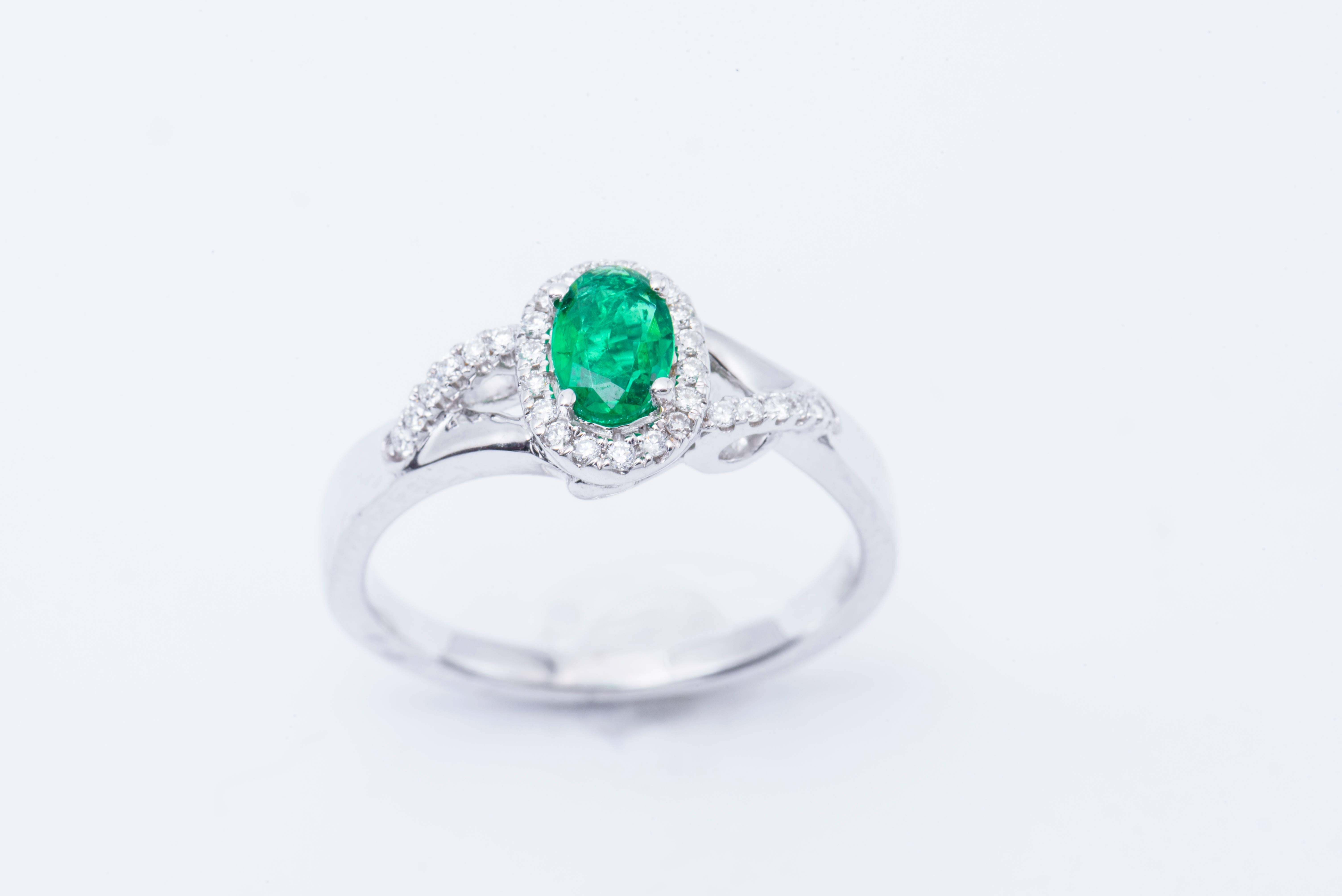 Contemporary Emerald and Diamond Halo Engagement Ring