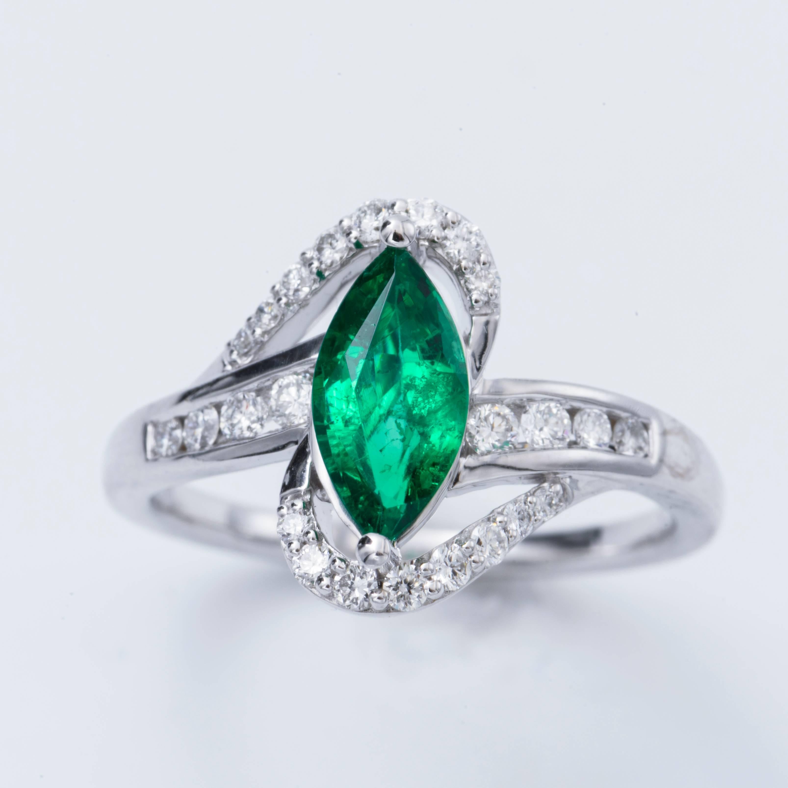 14K  White Gold with Marquise Zambian Emerald measuring 9x4.5 mm and weights 0.85 cts. The  Diamonds weight is 0.34 cts Color: H Clarity SI in clarity