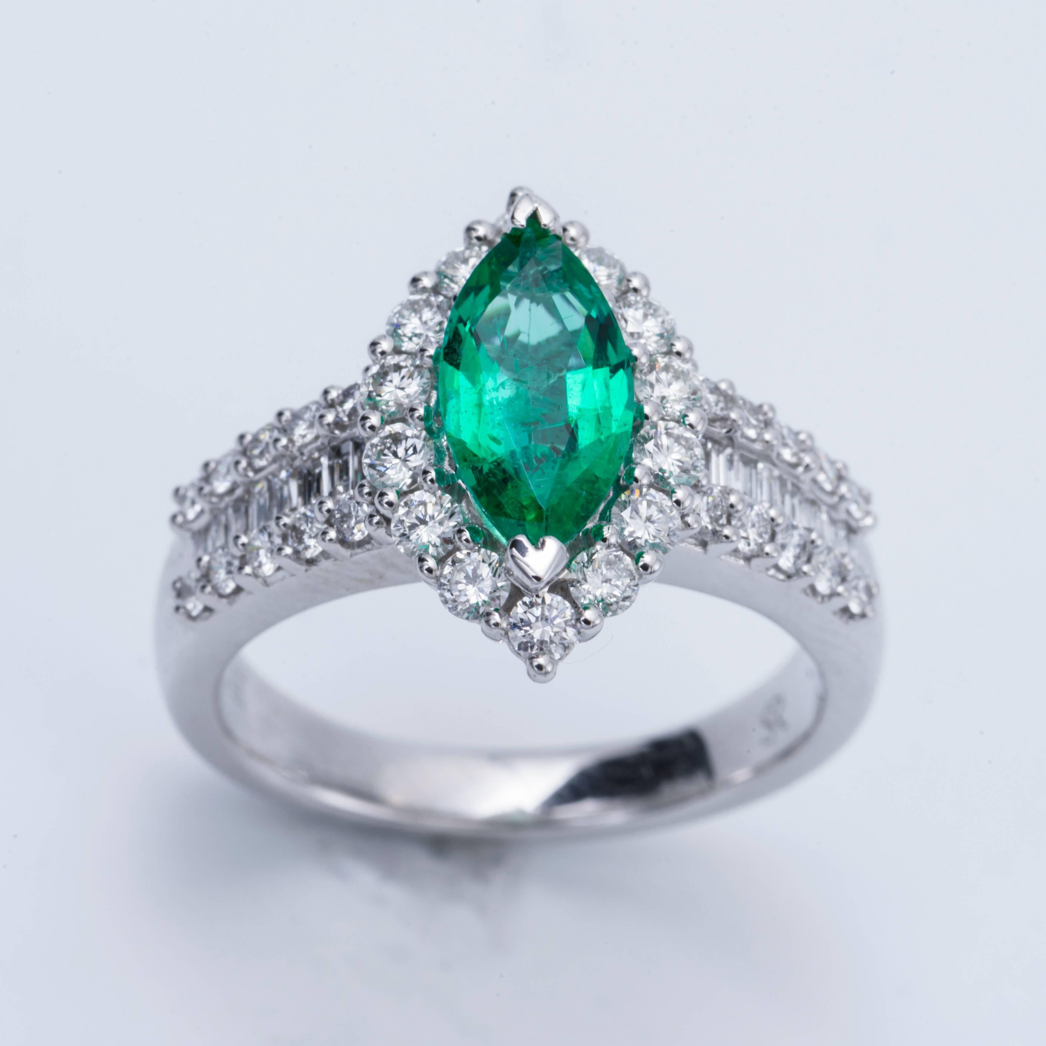 Style: 14k White Marquise Shape Zambian Emerald  Diamond Halo Engagement Ring
Material: 14k White Gold
Gemstone Details: 1 Marquise Shape Zambian Emerald approximately 0.88 ct. 10x5 mm
Diamond Details: Approximately 0.92ctw of diamonds. Diamonds are