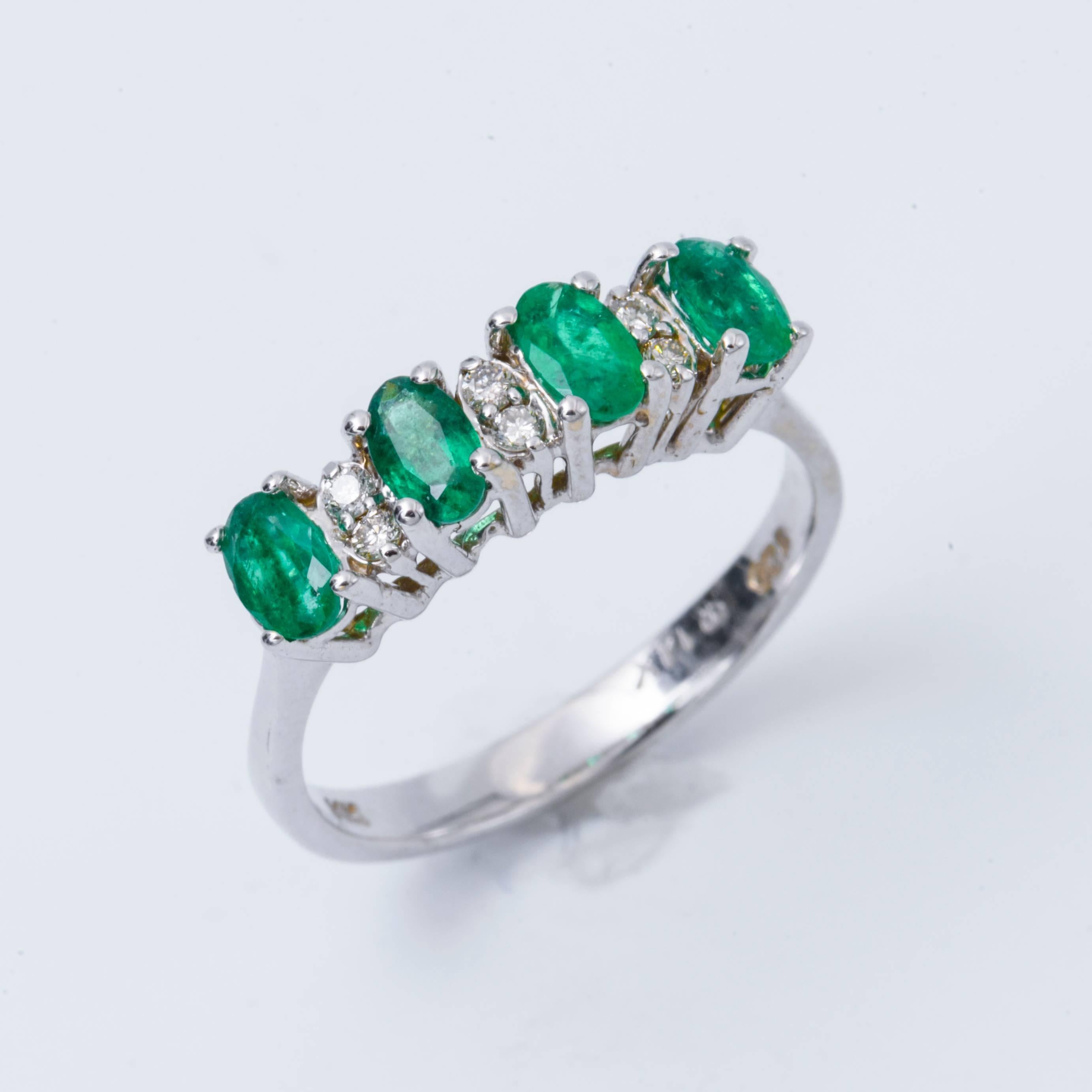 Style: 14k White Gold  Oval Shape Emeralds   Diamond  Band Engagement Ring
Material: 14k White  Gold
Gemstone Details: Each Oval Shape Emerald approximately . 5x3 mm for a total Weight of 0.88 Cts.
Diamond Details: Approximately 0.09 ctw of