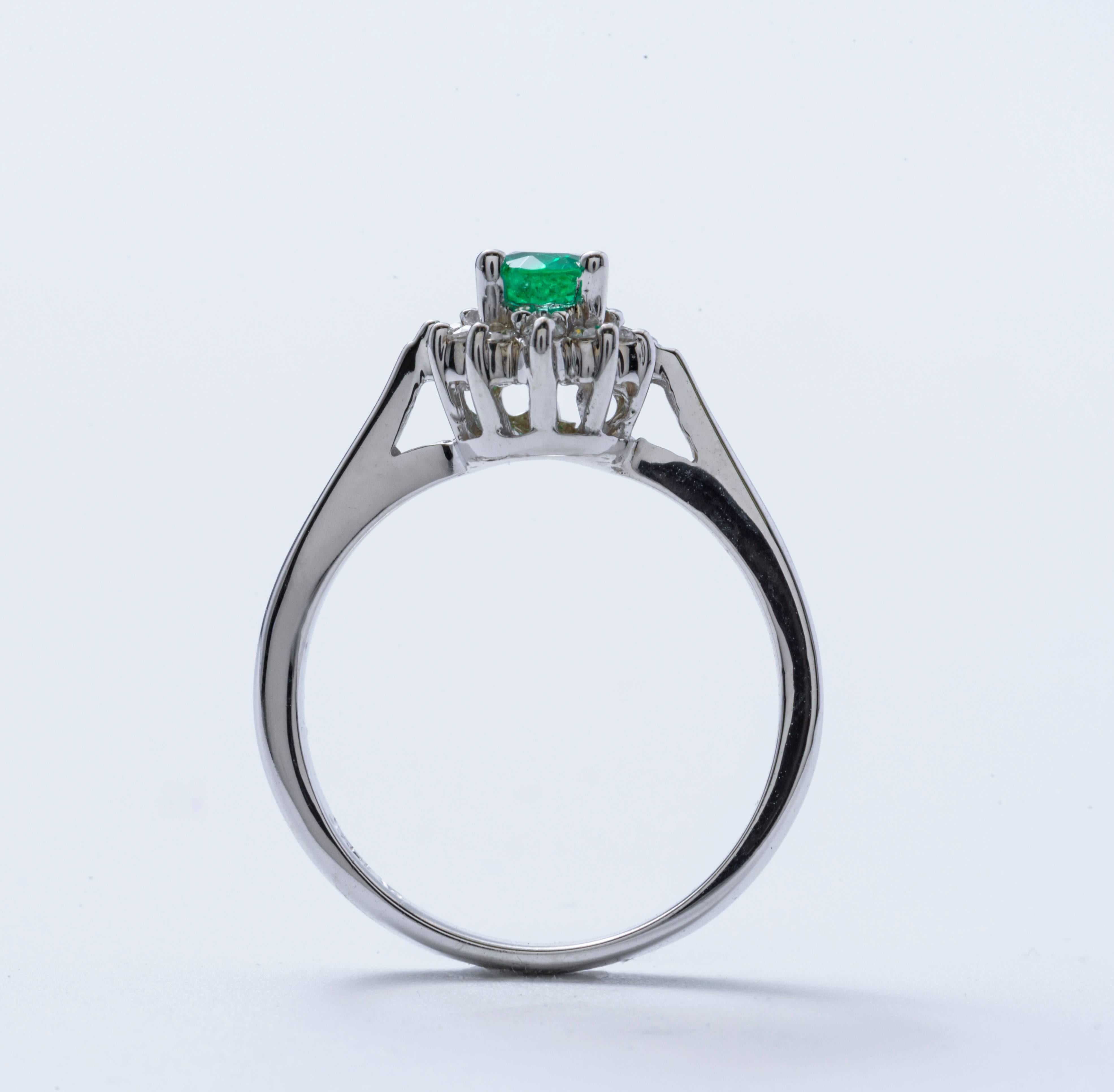 Contemporary Oval Shape Emerald and Diamond Halo Engagement Ring