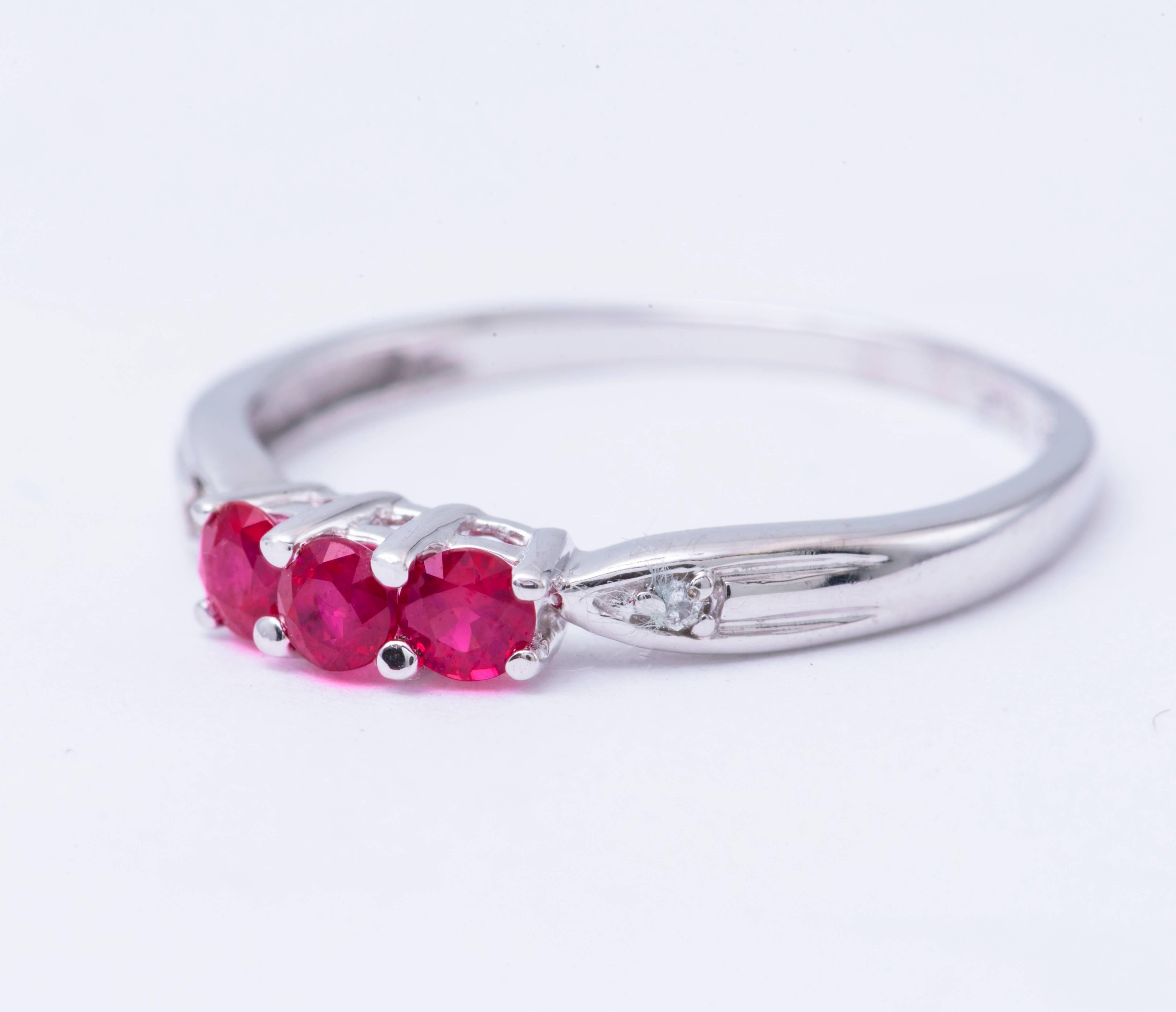 14k White Gold  Round Shape Ruby Diamond Band Ring
Material: 14k White Gold
Gemstone Details: 3 Round Shape Ruby approximately 0.45 ct.Total Weight 3 mm each
Diamond Details: Approximately 0.02 ctw of diamonds. Diamonds are H in color and SI in