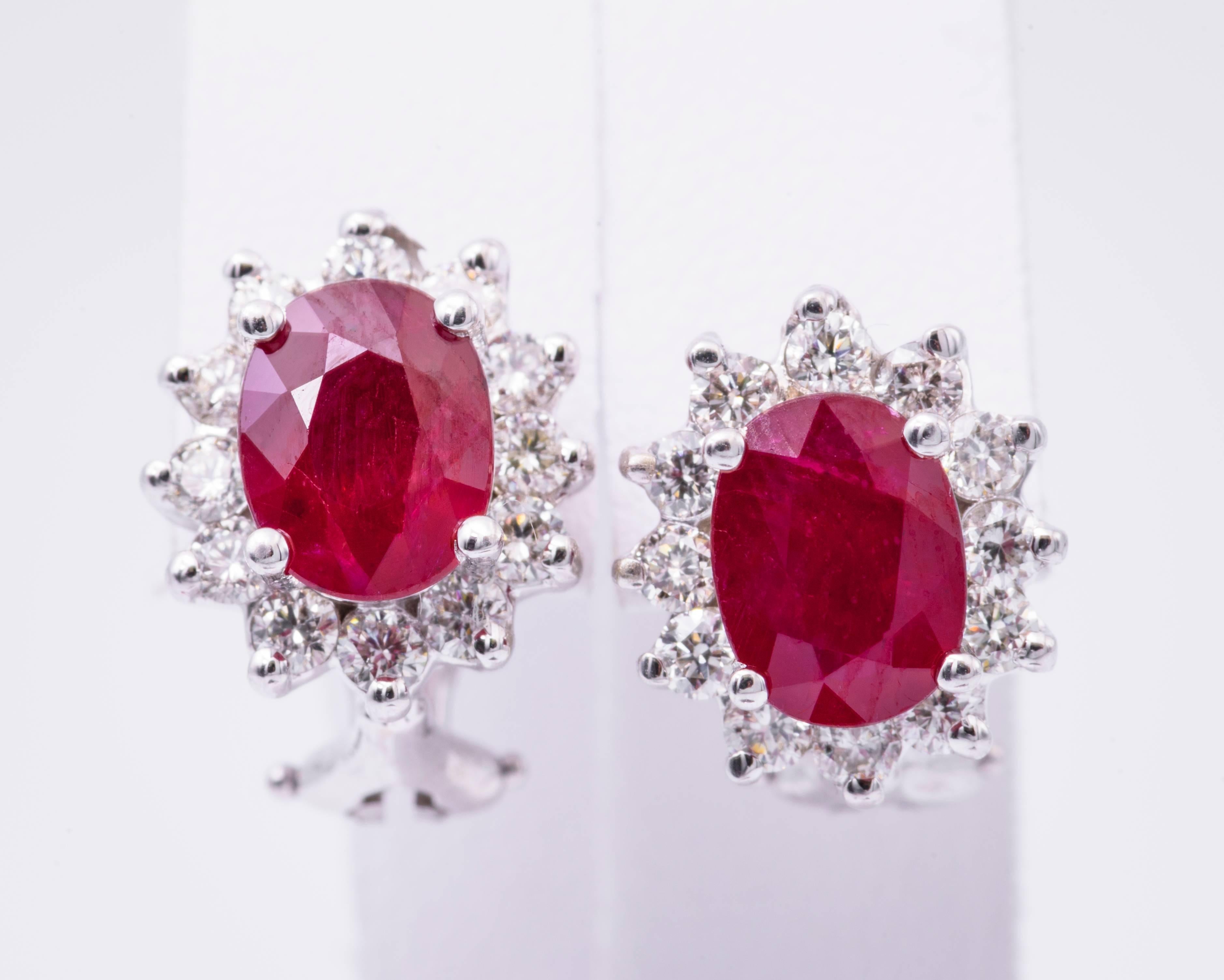The oval ruby in these earrings have a total carat weight of 3.20 carats, and they measure 8x6 MM.. The diamonds have a total carat weight of 0.94 carats.
The diamonds are H color and clarity is SI2.
The ruby is  very bright and nice.
12.5 X 10.9