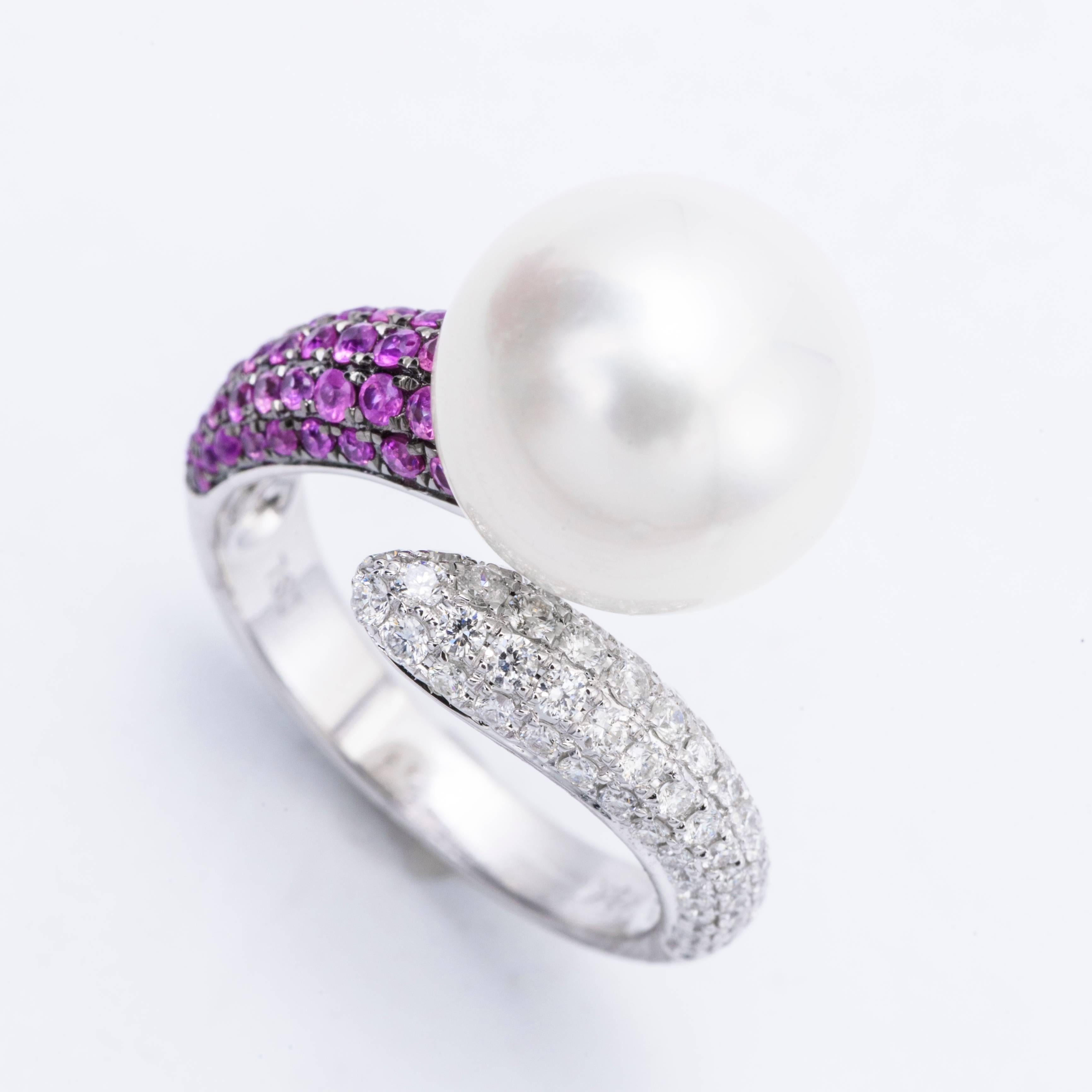 This exceptional ring features: 18K White gold
Pink Sapphire weight: 0.48 Carats
Diamonds Weight:: 0.46 Carats
South Sea Pearl; 12-13 mm 
Ring size: 6.5 We Re size free of charge