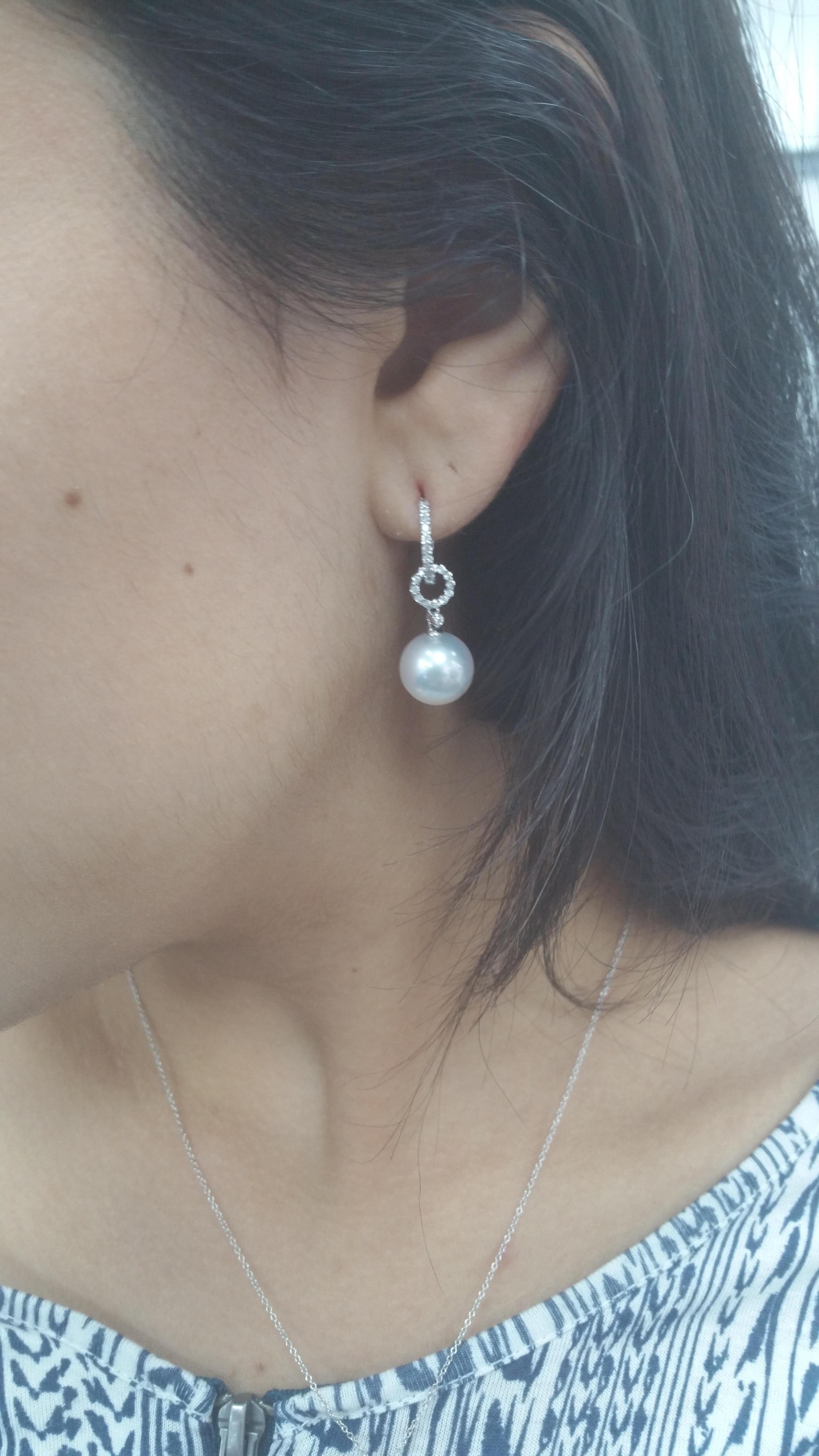 18K White gold drop earrings featuring two South Sea Pearls measuring 10-11 mm flanked with round brilliants weighing 0.29 carats. 

Luster: AAA Excellent
Pearl Quality: AAA