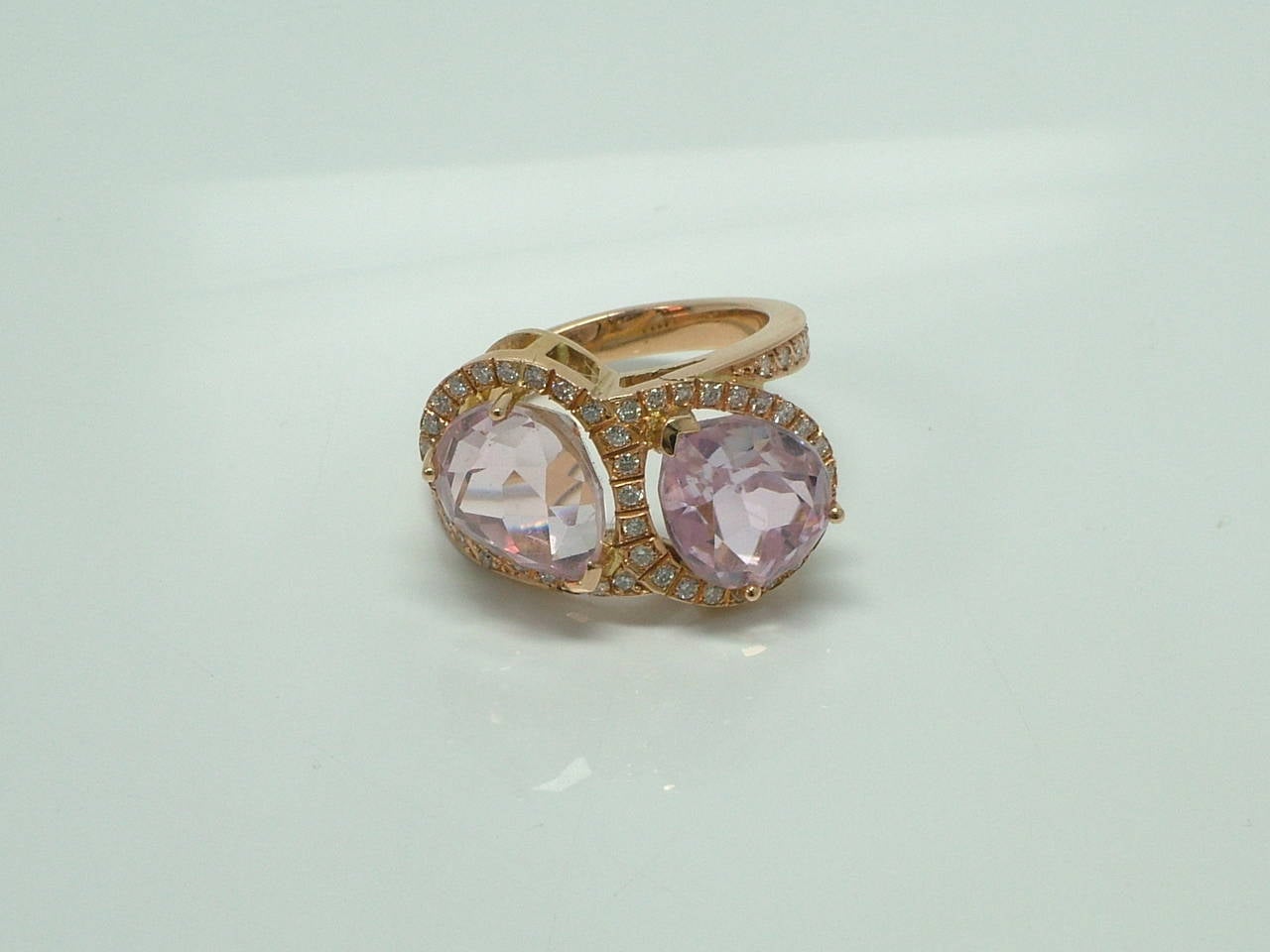A kunzite two stone ring. The pear shaped kunzite approximately 11x9mm, accented by brilliant shaped diamonds weighing 0.50 carats.

Internal diameter:19mm
Size:  EU 16.5  US 7.75
Ring sits approximately 9 mm from the finger