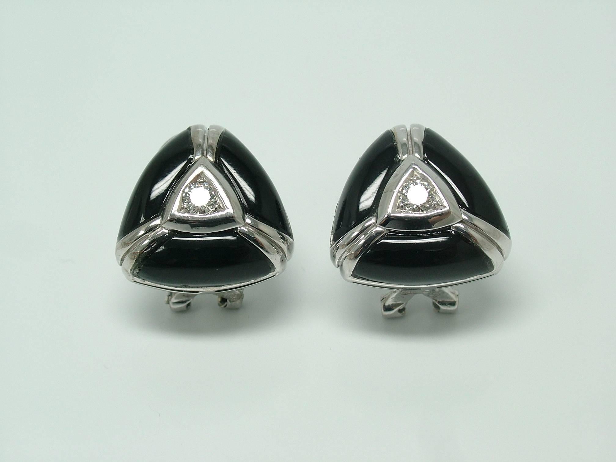A pair of 18 karat white gold, diamond and onyx clip earrings. An elegant pair every day earrings with a geometrical design. In the center with 2 diamonds weighting 0,25ct. surround by onyx.