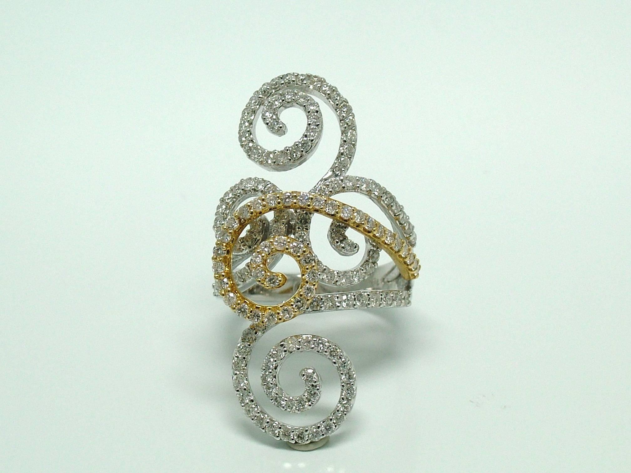 18 karat white and yellow gold ring set with brilliant cut diamonds weighting 1,80ct. The interesting shapes and curves seem to curl up like a delicate vine.

Finger size - 14 EU / 6¾- 6½ US / N - N½ UK
17.25mm inside diameter
Can be resized if