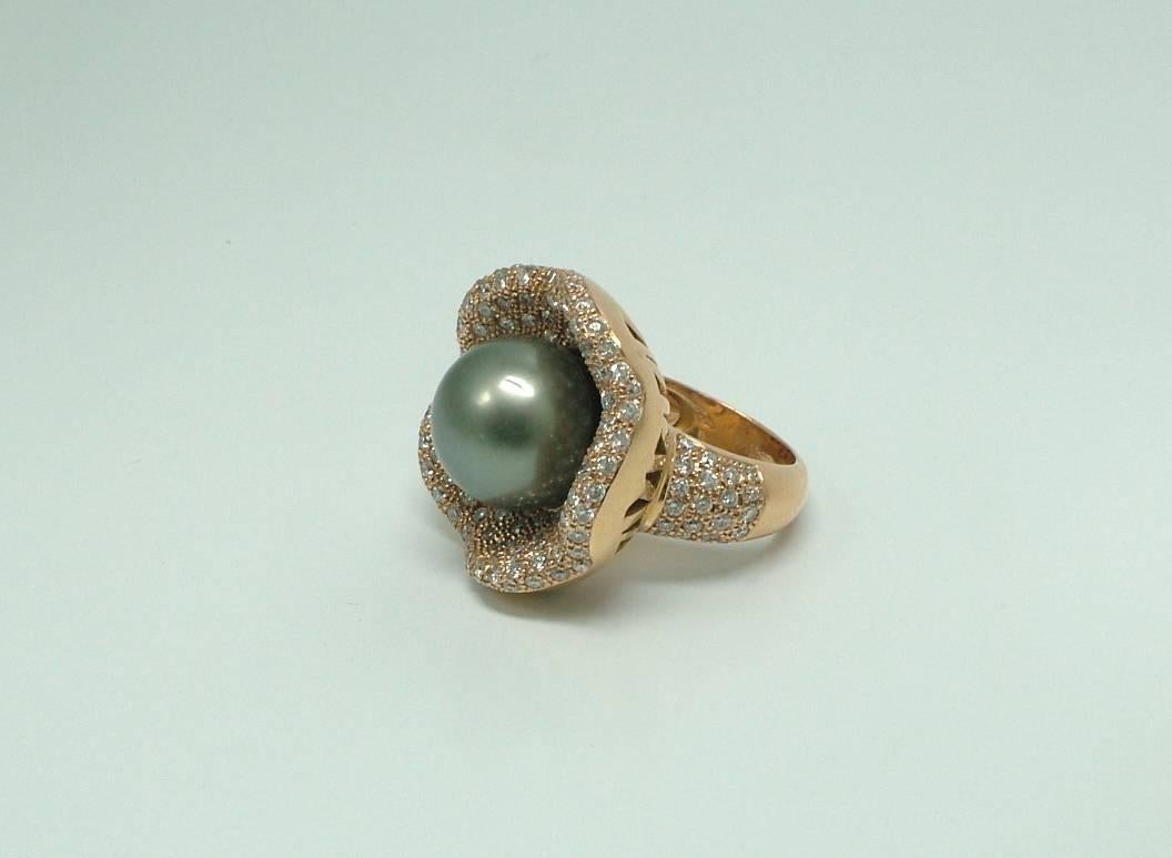 13mm Tahitian cultured pearl, surrounded by brilliant cut pave set diamonds.
This gorgeous Tahitian pearl ring is mounted in 18K yellow gold.

Size- 12 EU 6 US
Internal diameter- 17 mm
The ring sits approx. 15mm from the finger.
Brilliant cut