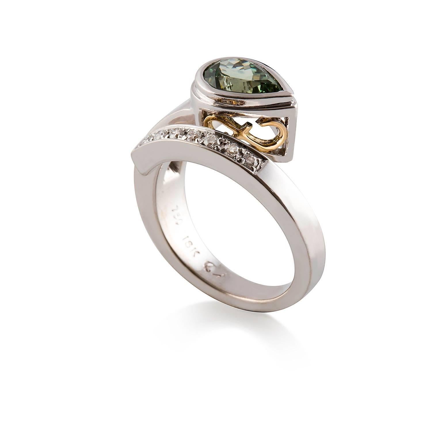 Zaffiro Cobra Ring

This handmade Cobra inspired design features a gorgeous lively green sapphire which is set in a fancy stepped chenier complimented with inset yellow gold scroll design. The setting is attached to the flared part of the band which