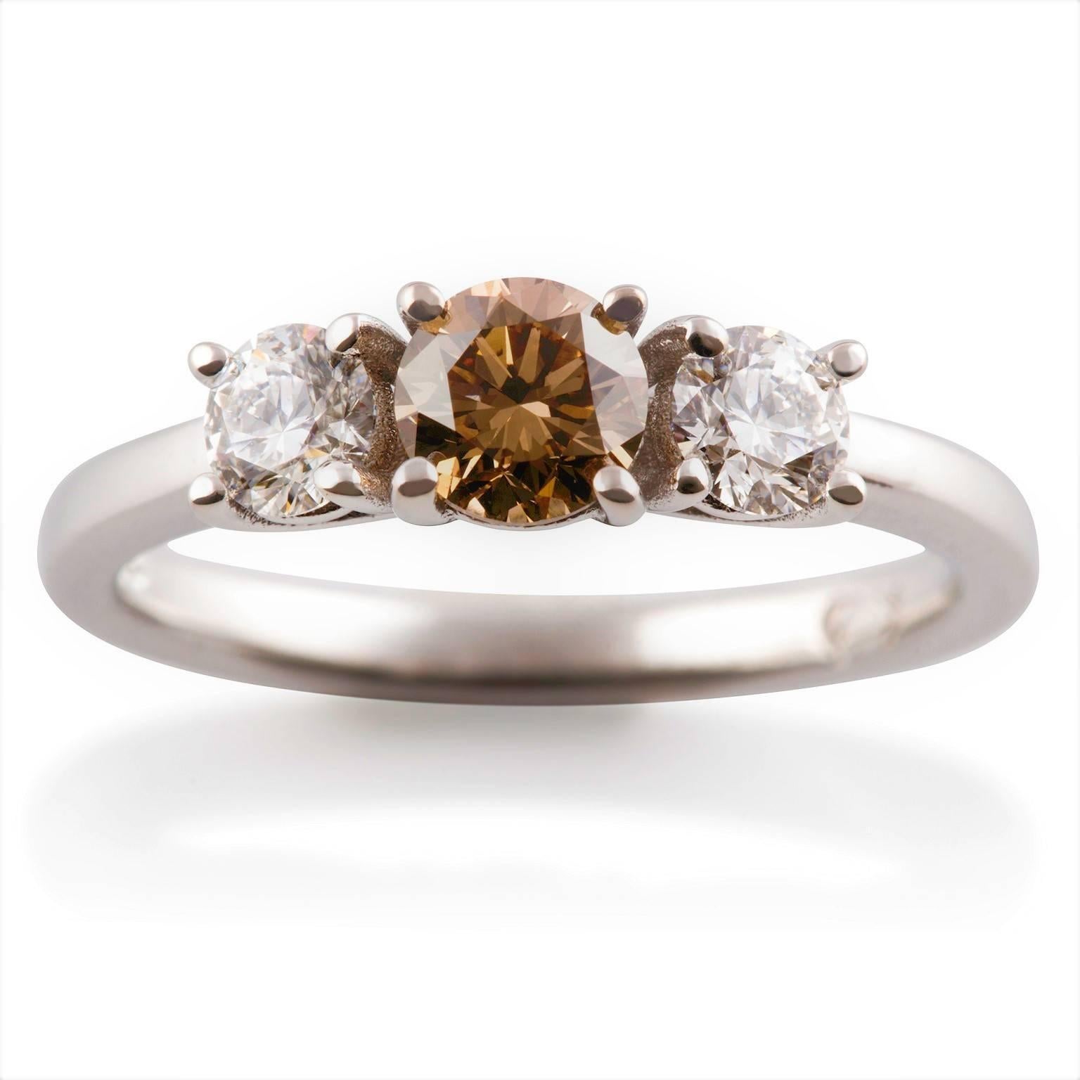 Cognac  & Ice Ring

Beautiful and understated, this ring is set with an attractive Argyle cognac diamond with a finest white diamond on either side.

1  x Round brilliant cut diamond: Cognac colour, VS clarity, 0.52 carat total weight

2 x Round
