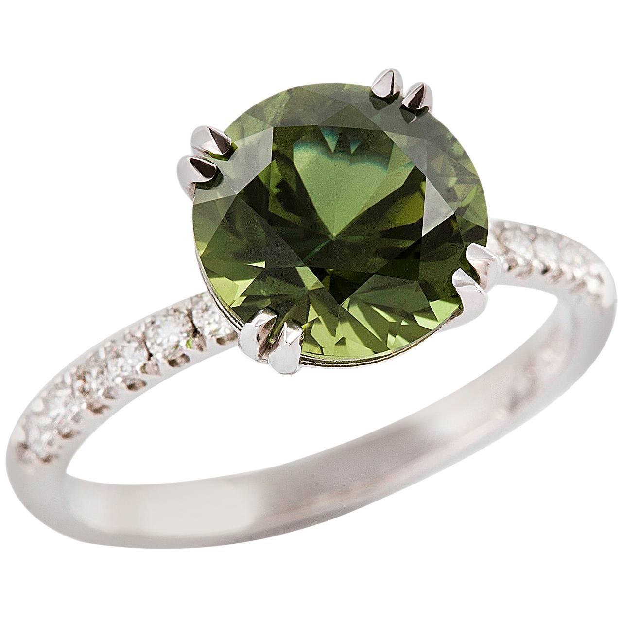 
Verde & Bianca Ring

Simply charming! This 18ct white gold ring is set with a beautiful green sapphire which has petite finest white diamonds on either side.

Round faceted sapphire: medium blue-green colour, 3.67ct

Round brilliant cut diamonds: F