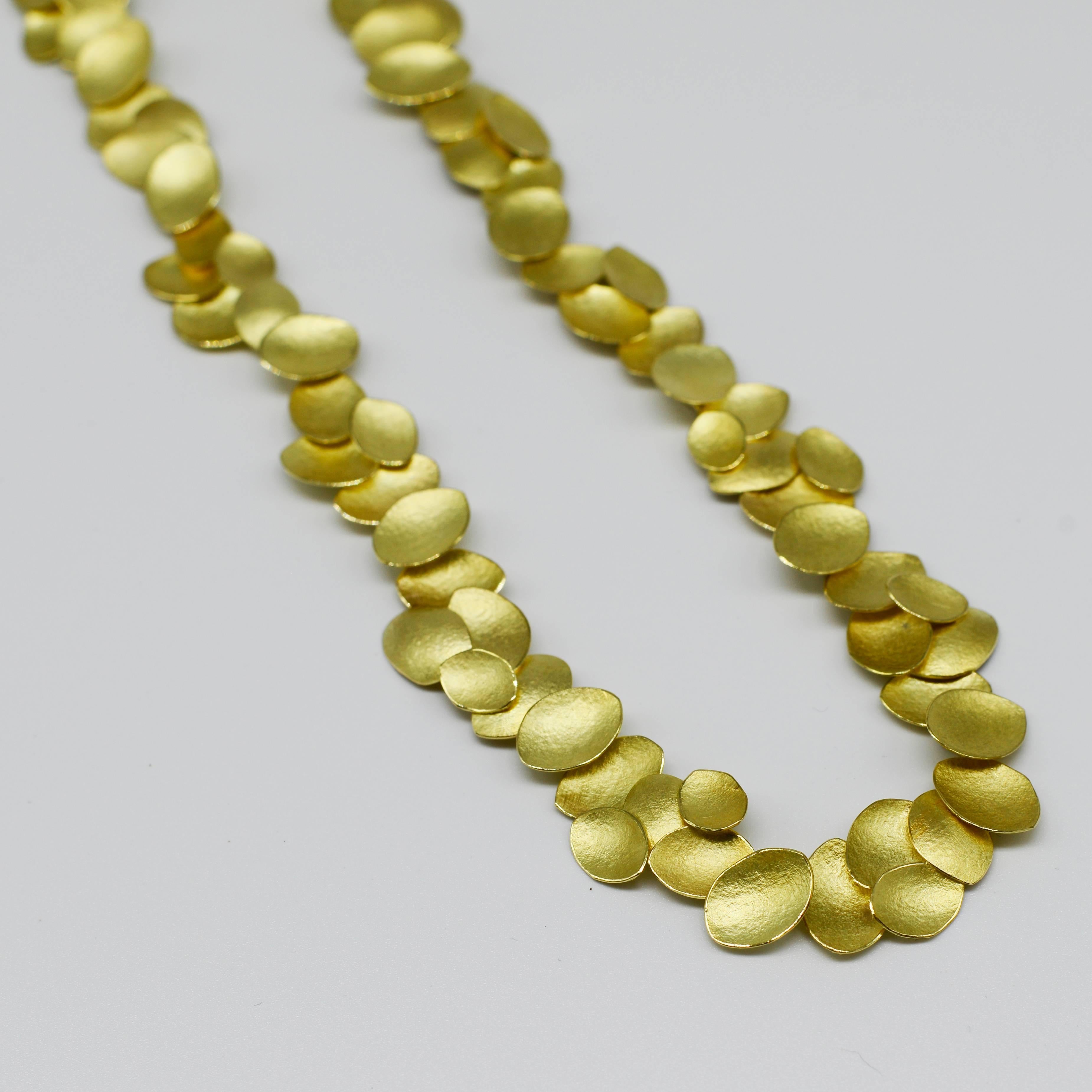 Layers of petals create rhythm and movement. Each individual 18ct gold petal is cut out and formed by Kayo Saito and her team. Because the necklace is hand crafted, you will never find an identical copy; it is unique to you.  The petals are
