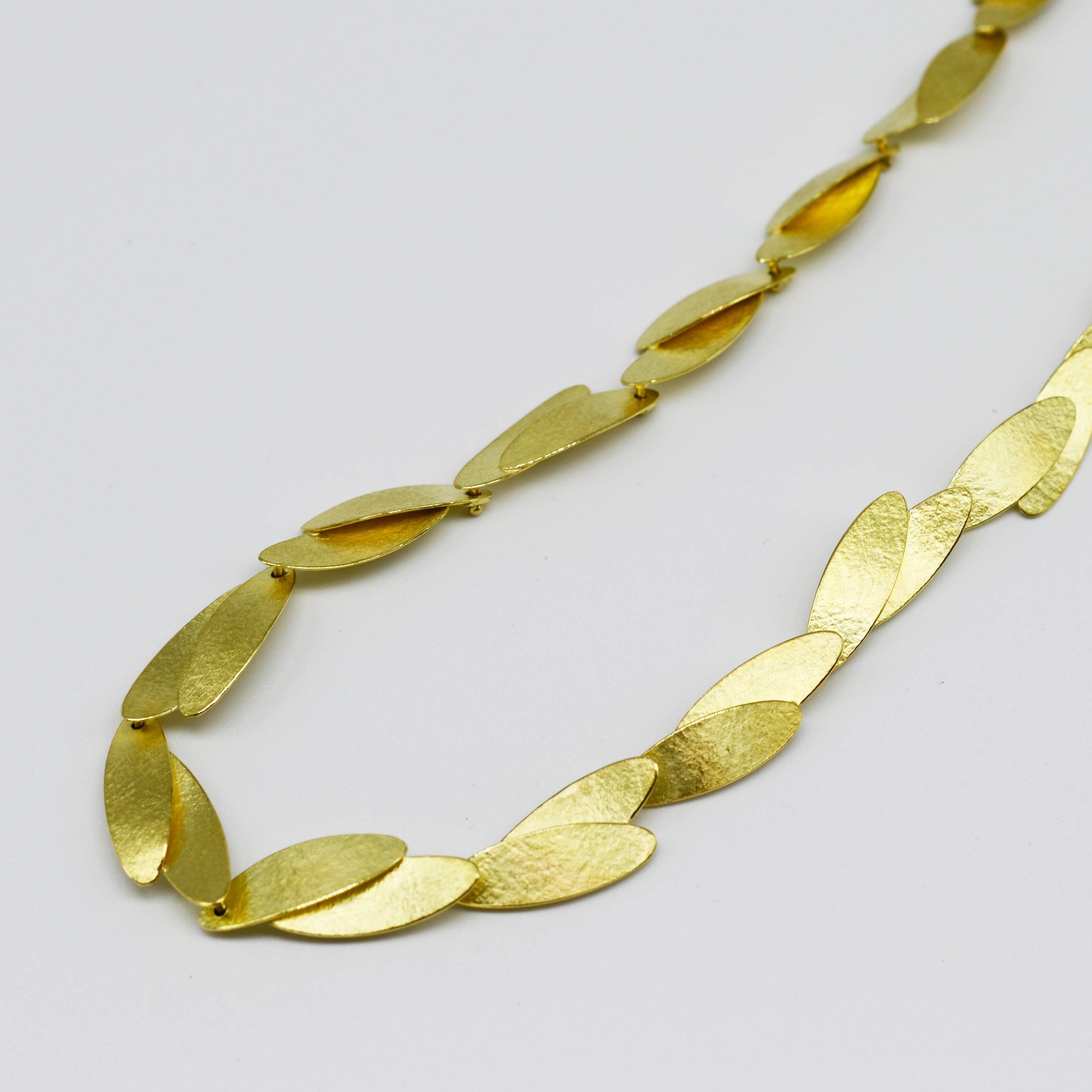 Layers of stylized laurel leaves, create rhythm and movement. Each individual 18ct gold leaf is cut out and formed by Kayo Saito and her team. The leaves are carefully balanced for maximum comfort and stability when worn around the neck. They have a