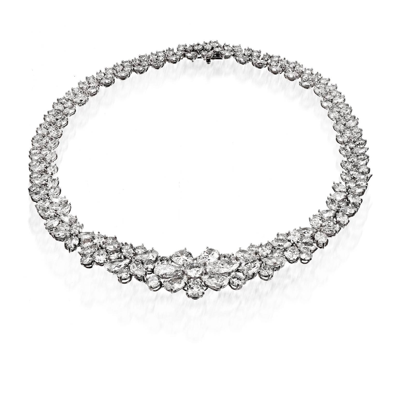 Platinum 76.00 Carat Diamond Collar Necklace.

This stunning diamond necklace is crafted with substantial size diamonds all throughout. 

The focal point is a flower motif that is comprised of 6 pear cuts and one marquise cut diamond all mounted