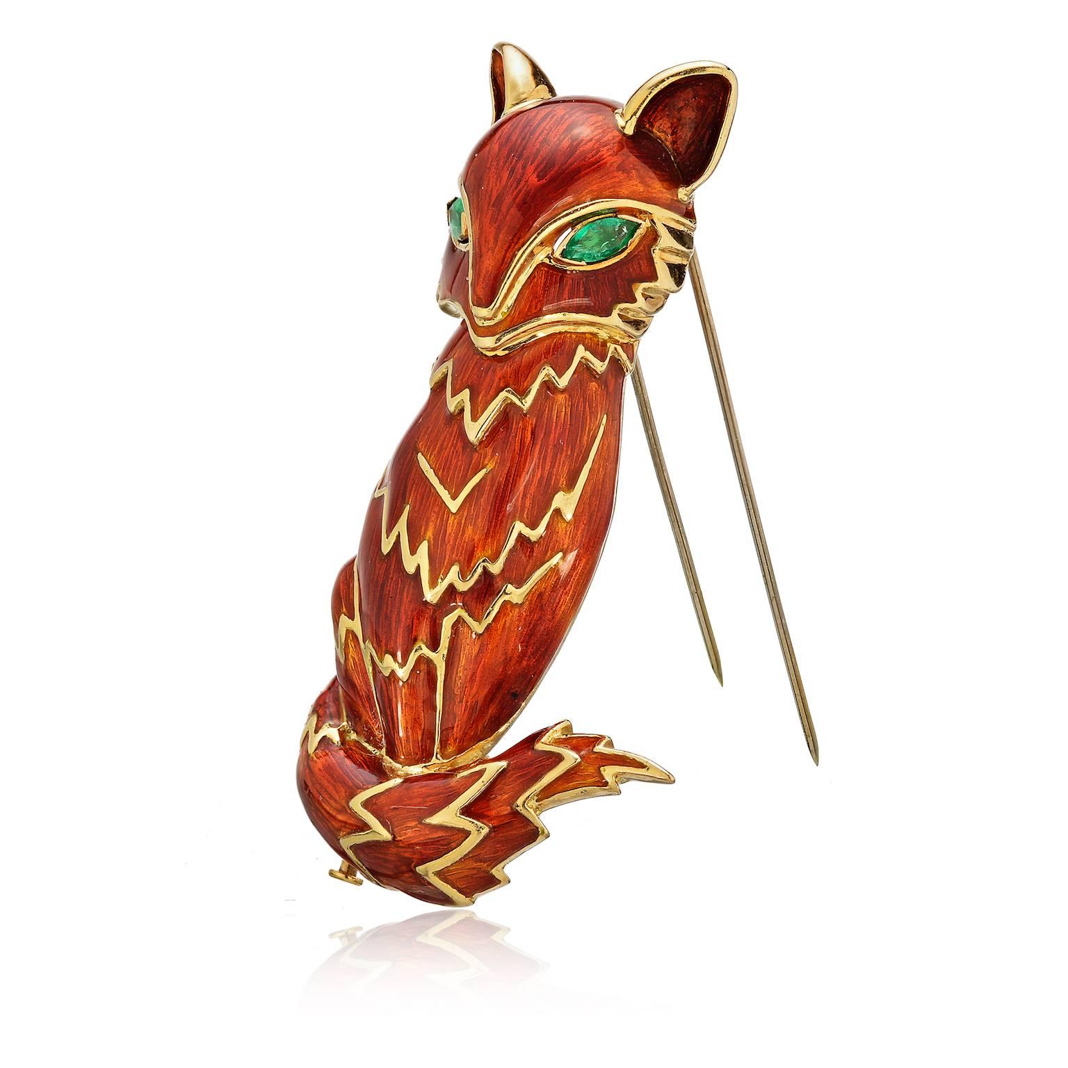 David Webb red enamel fox vintage brooch. Marked 18K yellow gold in the form of a seated fox with red-orange enamel, marquise-cut emerald eyes.  Emeralds are approx. 7mm x 3.5mm, 3” tall, 36.1dwt.

Dimensions: 7.5cm x 2.5cm ( 3 x 1in)
Gram Weight:
