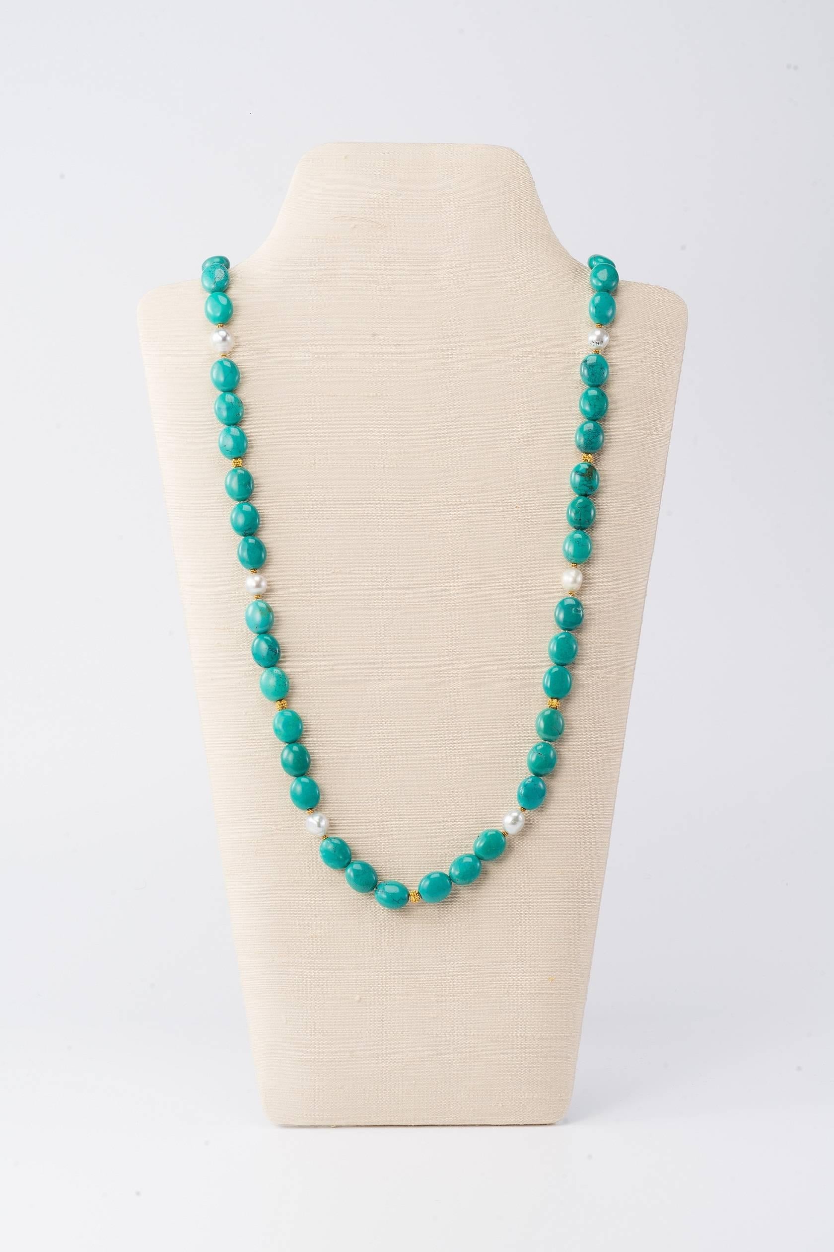 36 in (91.5cm) long necklace with Tibetan turquoise, South Sea pearls and 18 karat gold beads

These beautiful turquoise disc beads lay flat when worn and hang comfortably. The colour is gracious and is beautifully accented by the South Sea pearls