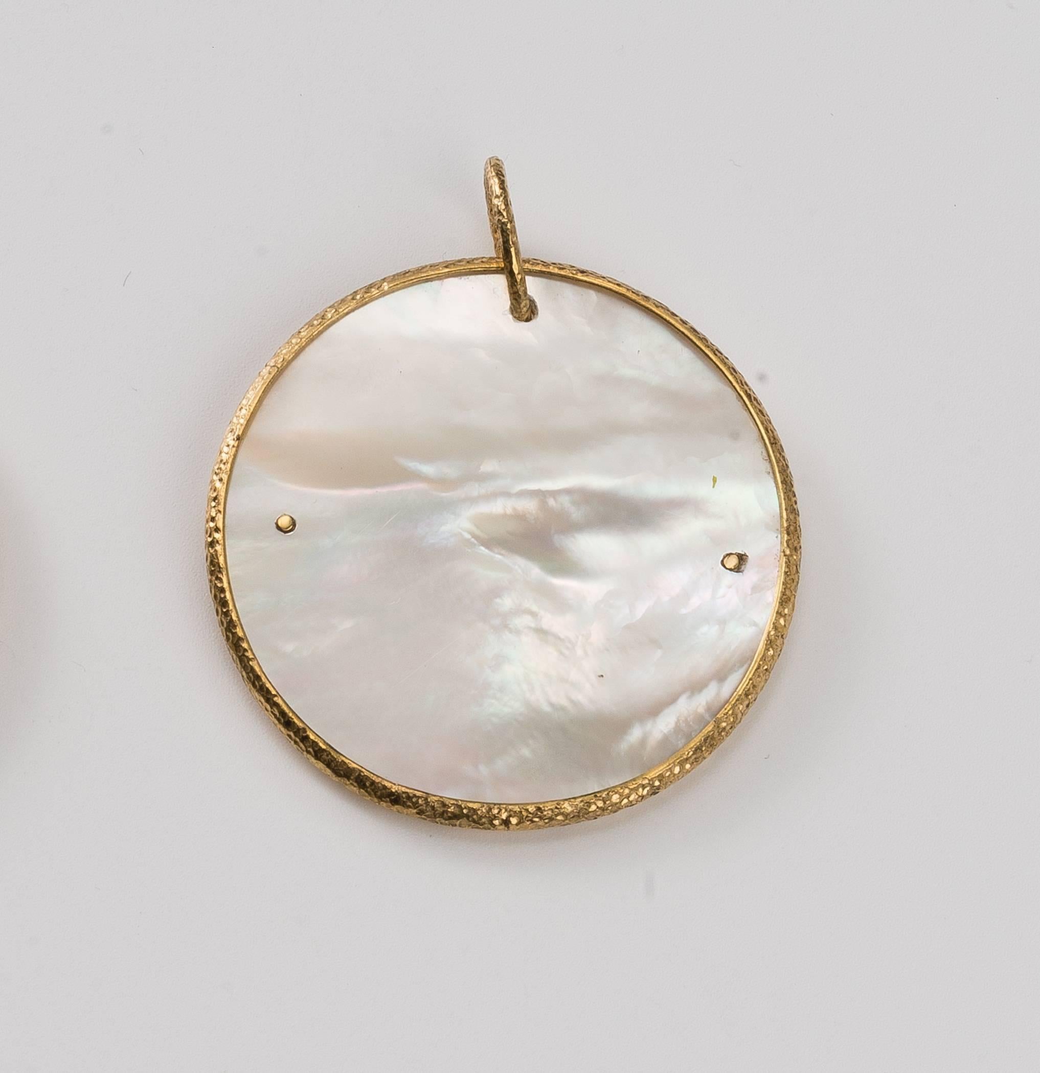 From our Heritage Collection of Chinoiserie designs, the luminous mother-of-pearl pendant is wrapped in hammered gold with ruyi clouds, 1 3/8 in (3.5cm) dia. The ruyi cloud is an auspicious symbol of wisdom and heavenly blessings. 
