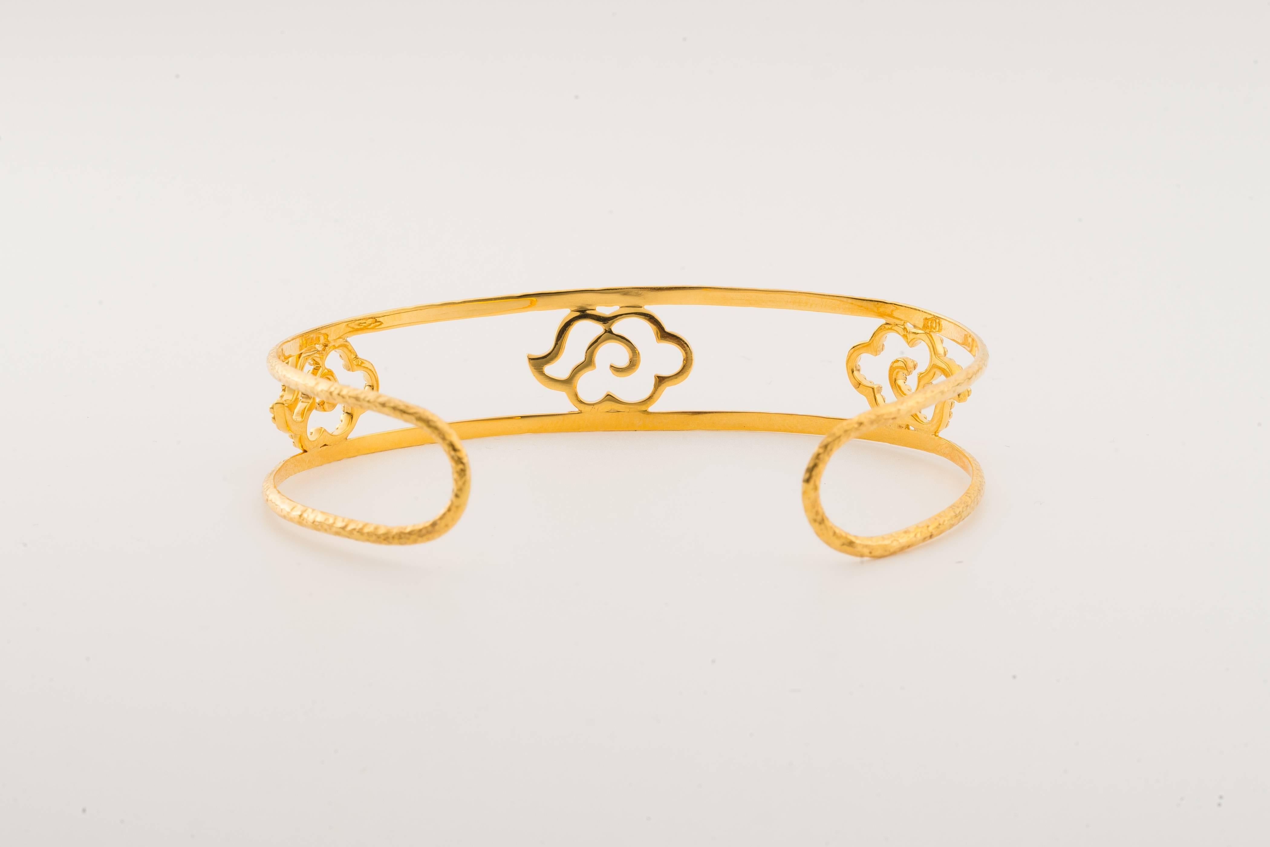 The hand-worked 18-Karat gold cuff is from our Heritage Collection of Chinoiserie designs, height ½ in (1.3cmH), the hand-hammered openwork cuff is decorated with cloud motifs (weight 11.32gm)
The cuff is flexible with a circumference that will