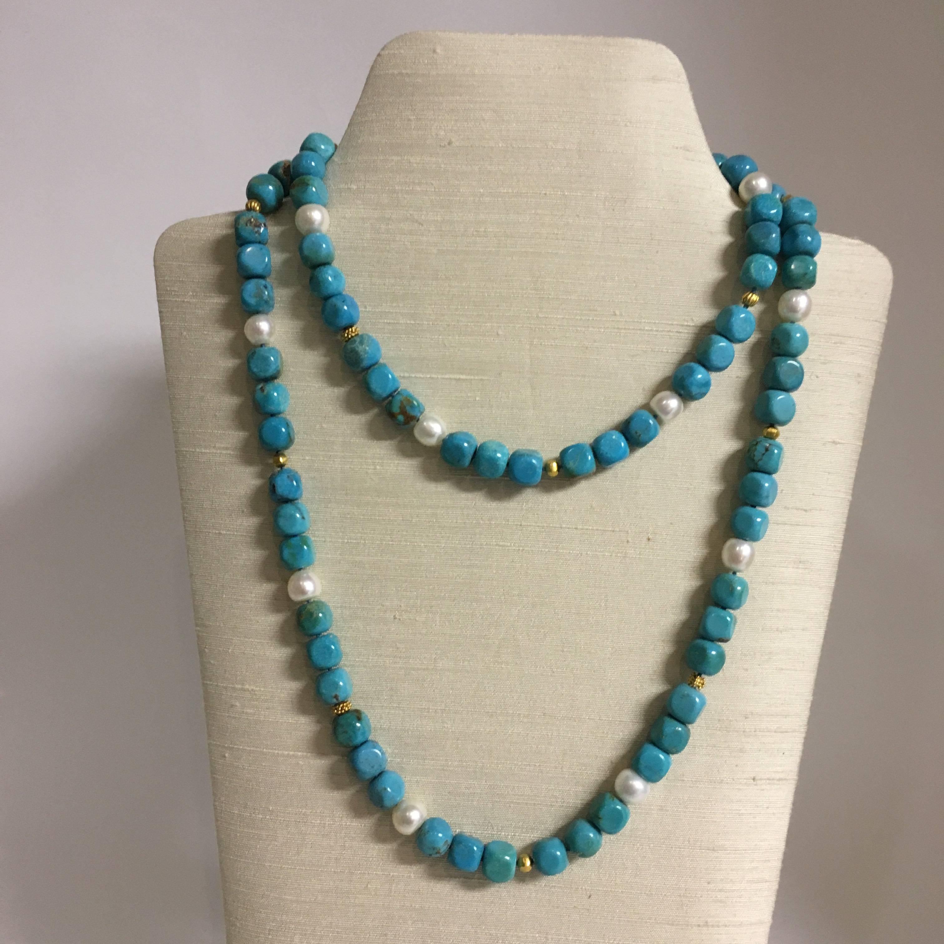 The long necklace 42” L (106cm L)  with slightly squarish round Tibetan turquoise beads is beautifully accented by freshwater pearls, 18K gold beads and S-hook clasp. It can be worn long as a single strand or doubled up and shorter.