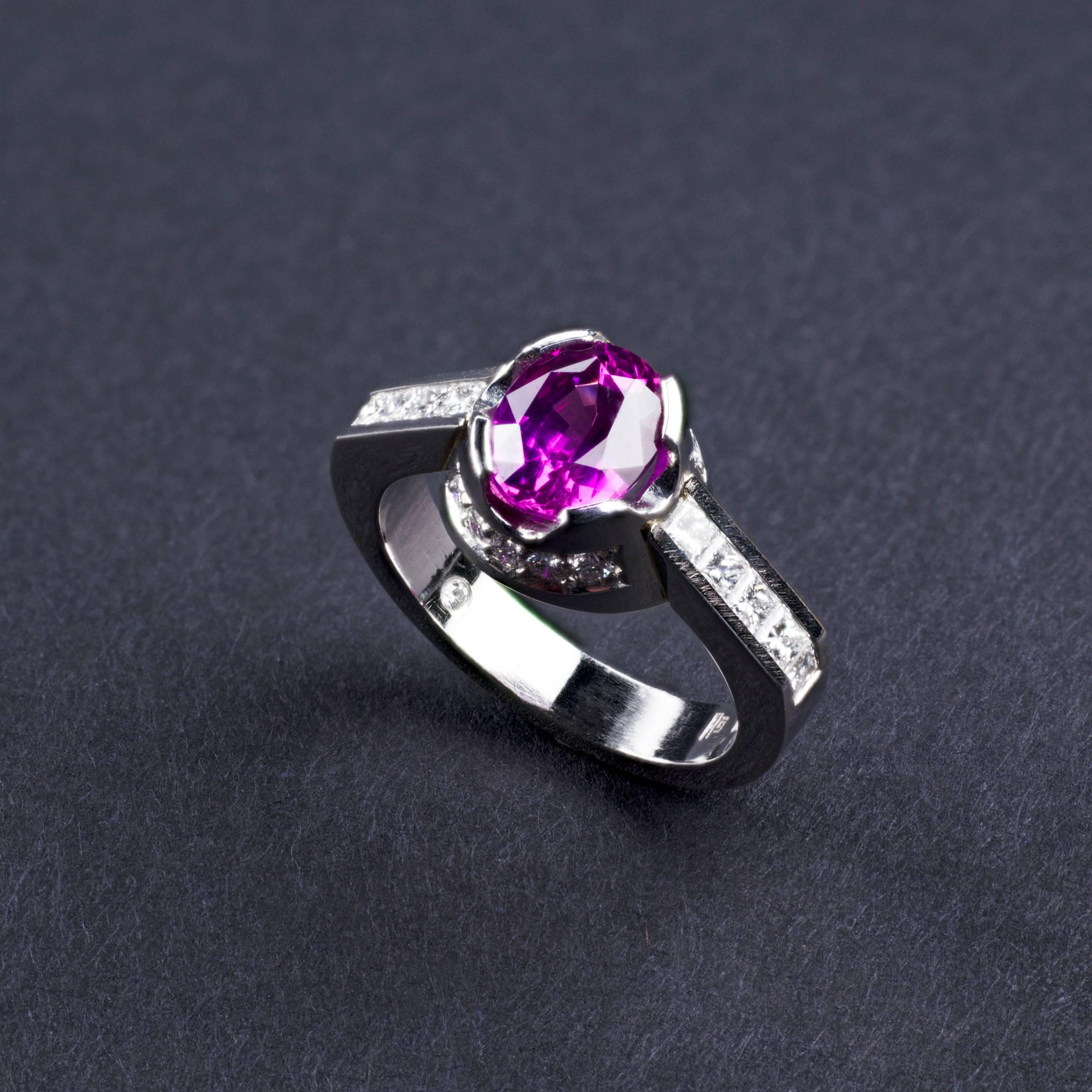 A contemporary classic, this elegant platinum ring is set with a 2.13ct oval natural pink sapphire from Sri Lanka.
The rare central gemstone is star and step cut and enhanced by fine princess cut 0.47ct rare white vvs and brilliant cut 0.19ct rare